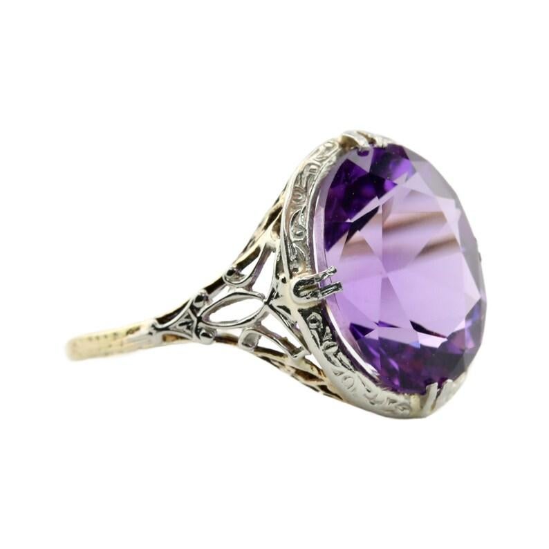 Aston Estate Jewelry Presents:

An Art Deco period Amethyst filigree solitaire ring. Centered by a rich vivid purple amethyst of 6.00 Carats. Accented by filigree scroll work through and engraved detailing.

Hallmarked as 14 karat