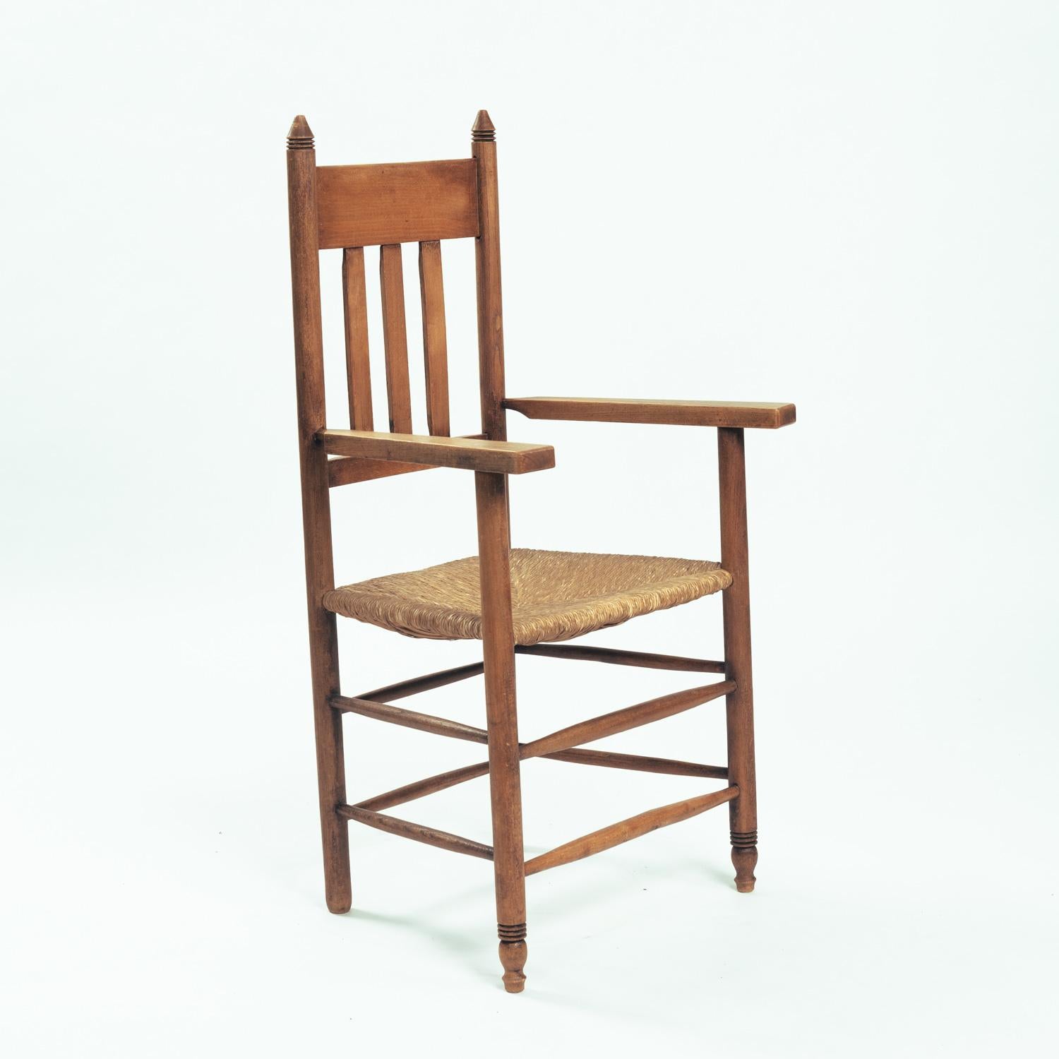 Oak armchair in Amsterdam school style, with straw seat, 1930
In good condition.

measurements: height 110cm x wide	54cm x depth 47cmseating height: 45cm