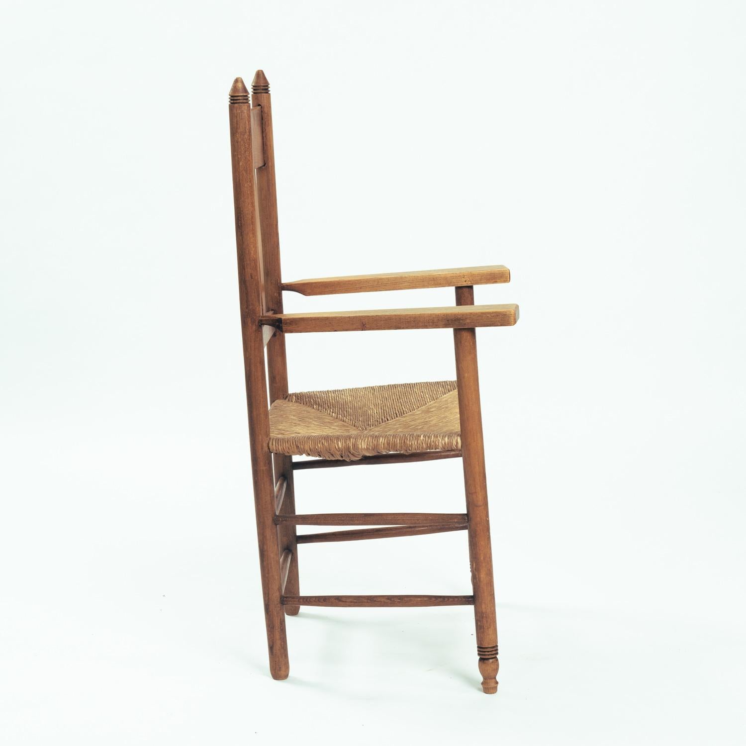Dutch Art Deco Amsterdam School armchair in oak with straw seat, The netherlands, 1930 For Sale