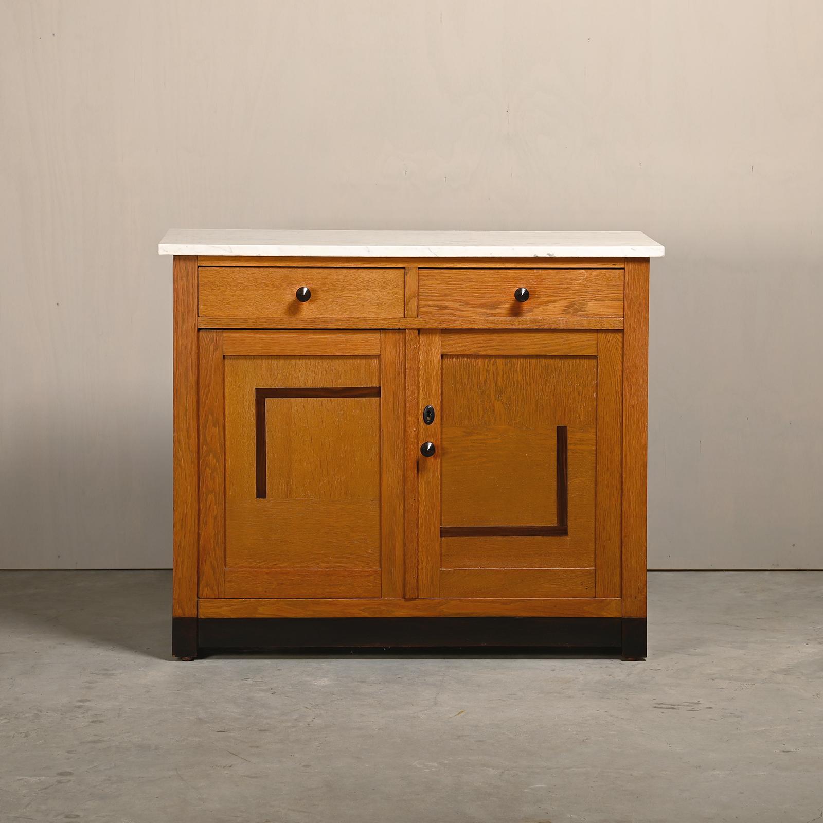 Wonderful Art Deco Amsterdam School Cabinet / Credenza / Sideboard from the 1930s. Solid Oak with Burl wood inlay decorations and top marble plate The sideboard has 2 drawers and hinged doors with 2 shelves. All in very good vintage original
