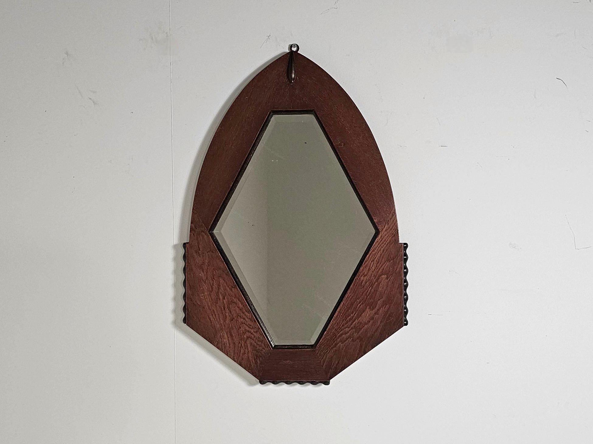 Striking and stylish, this Amsterdam School mirror from the 1920s–1930s is a true Art Deco statement piece. The bold geometric oak frame is enhanced by elegant black ball-shaped accents on the sides, giving it a distinctive architectural