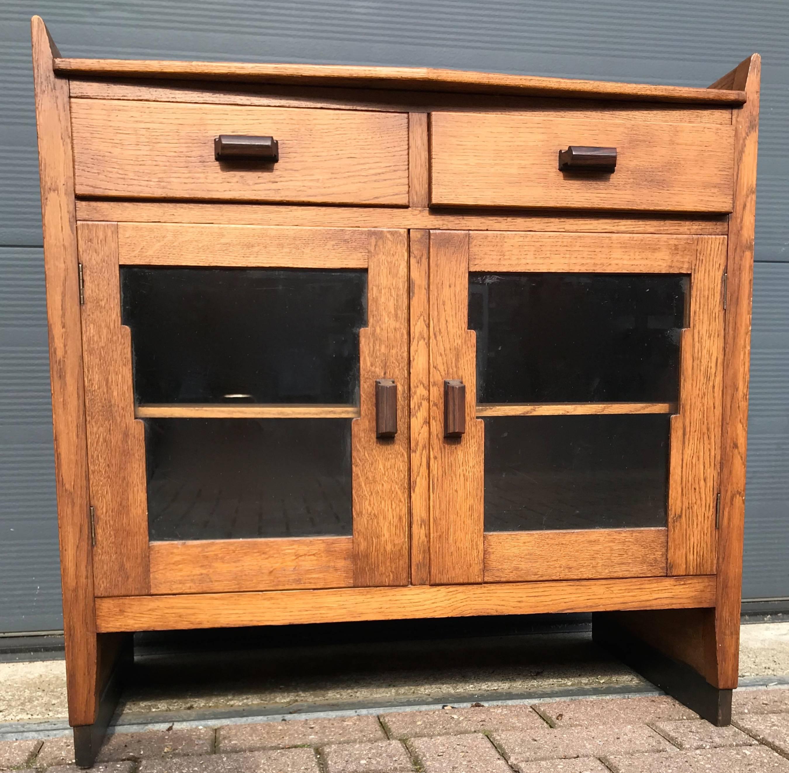 Beautiful design Amsterdam School drinks cabinet. 

This early 20th century design drinks cabinet is in the style of the Amsterdam School and the contrast in the light oak and the dark Macassar style elements makes it a joy to use and look at. This
