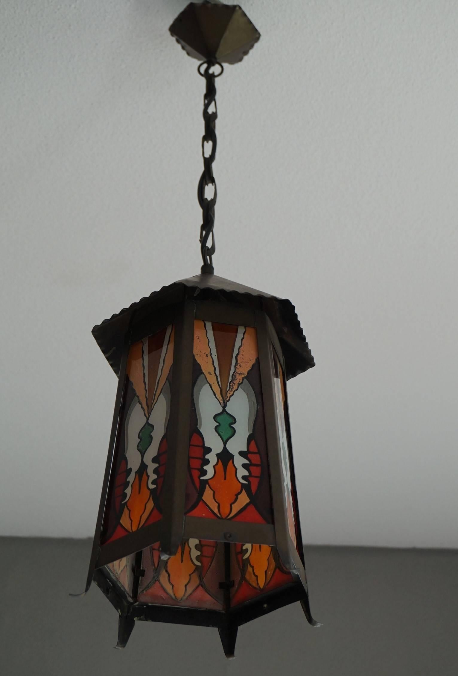 Colorful and stylish light fixture from the early 1900's.

This rare and highly stylish lantern was made in early 20th century Amsterdam and the colors of the painted glass combined with the marvellous patina of the hexagonal brass frame is a lovely