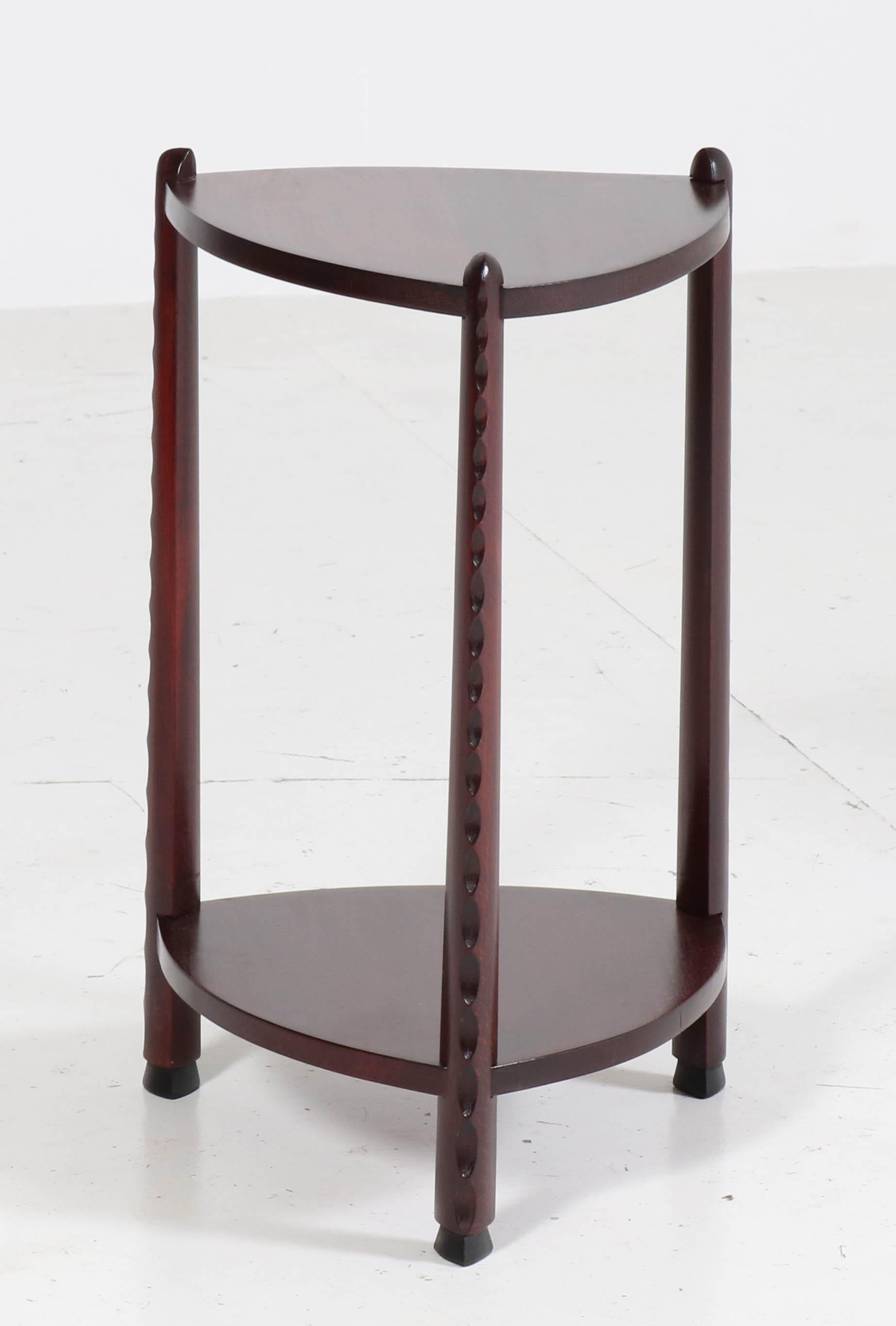 Magnificent and very rare Art Deco Amsterdam School side table.
Design attributed to Piet Kramer.
Striking Dutch design from the twenties.
Stained beech with a mahogany color.
Wonderful lining on the three legs.
In very good condition with