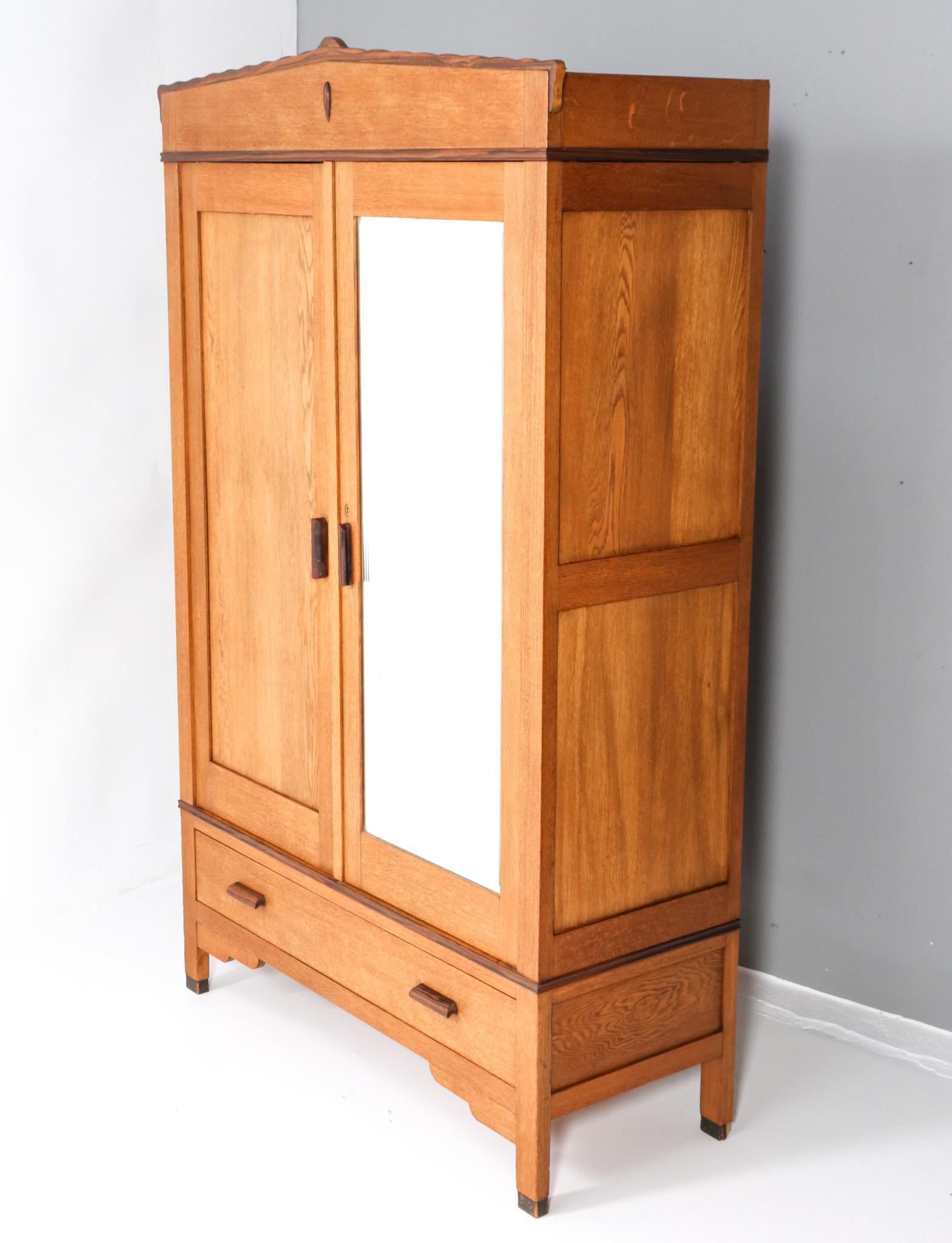 Magnifique et rare armoire ou penderie Art Déco de l'école d'Amsterdam.
Design/One. Forage Amsterdam.
Un design néerlandais saisissant des années 1920.
Base en chêne massif avec poignées et éléments décoratifs en ébène de macassar massif