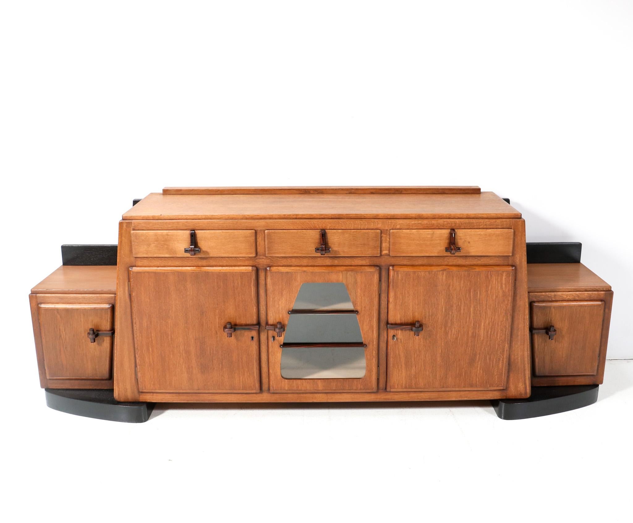 Magnificent and ultra rare large Art Deco Amsterdamse School credenza or sideboard.
Design by Pieter Vorkink and Jacob Wormser.
Striking Dutch design from around 1920.
Solid oak and original oak veneer base with original black lacquered