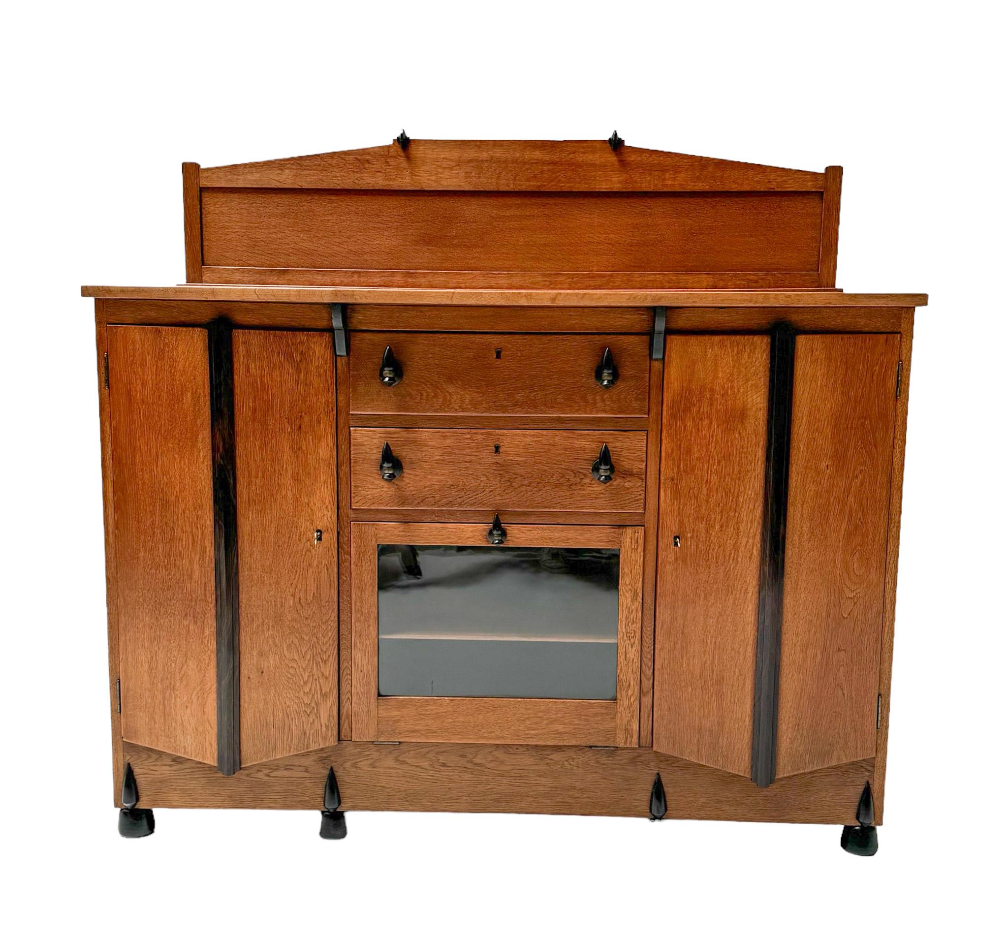 Magnificent and rare Art Deco Amsterdamse School credenza or sideboard.
Design by J.J. Zijfers Amsterdam.
Striking Dutch design from the 1920s.
Solid oak base with solid decorative macassar ebony knobs on drawers and drop-leaf door.
Original black