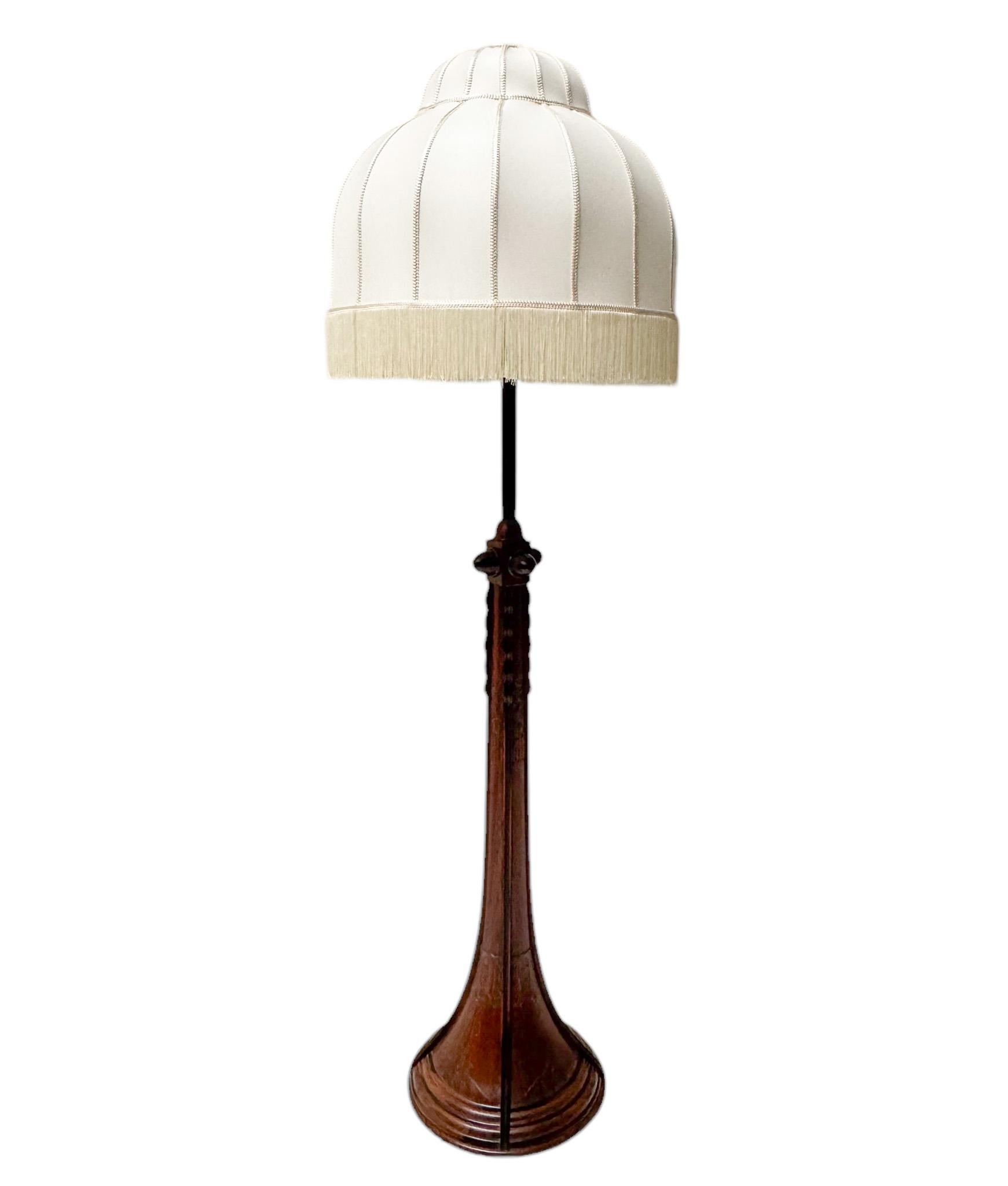 Magnificent and ultra rare Art Deco Amsterdamse School floor lamp.
Striking Dutch design from the 1920s.
Original solid walnut and macassar ebony base with original hand-carved decorative elements.
The original shade has been re-upholstered with