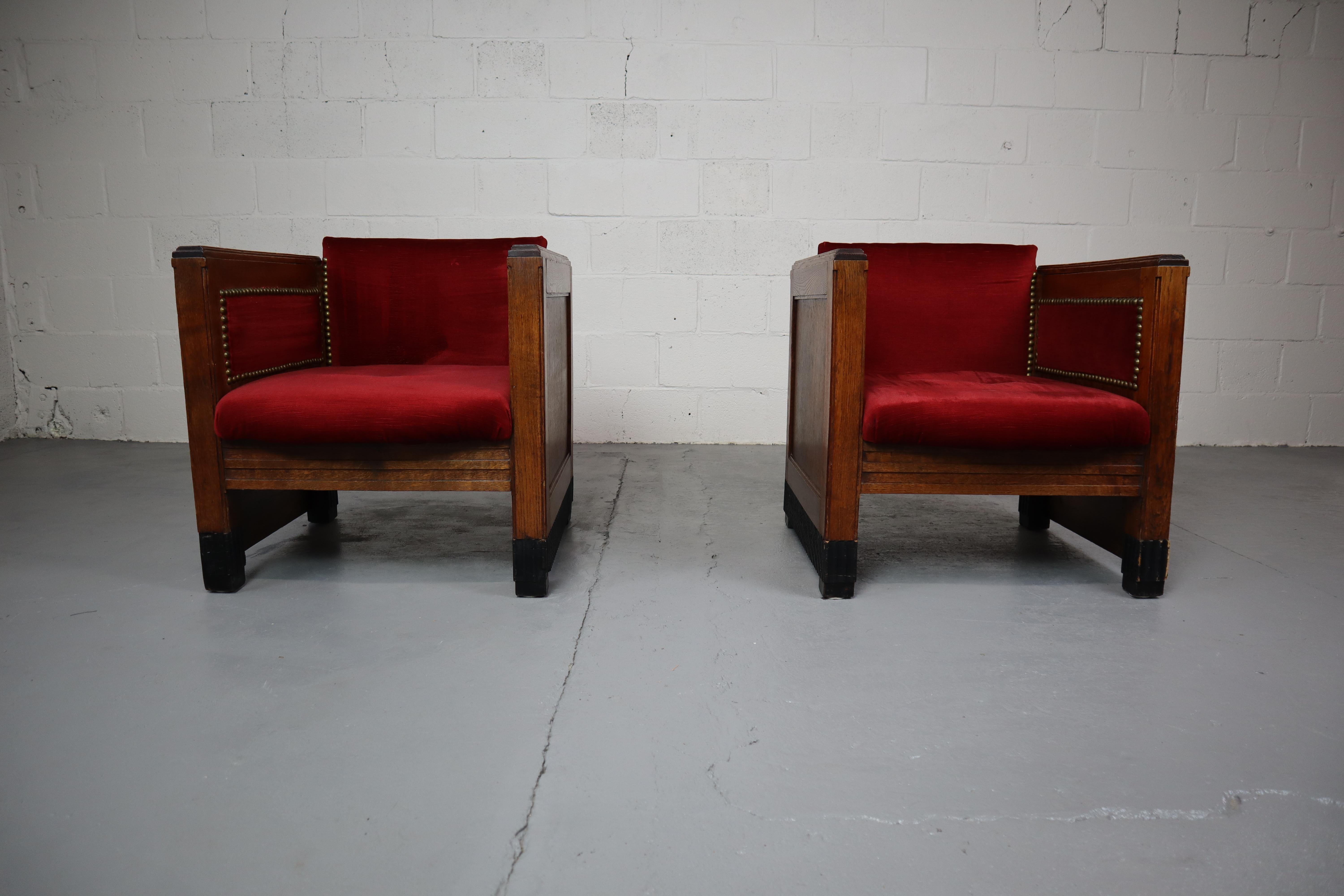 Pair of Amsterdam School seats. In solid oak and red velour upholstery. circa 1925.
The seats were reupholstered some 30 years ago.
There are some missing pieces on the lower black lacquered wooden edge.
Measures: 70 x 68 x 65 cm.
Seat height: