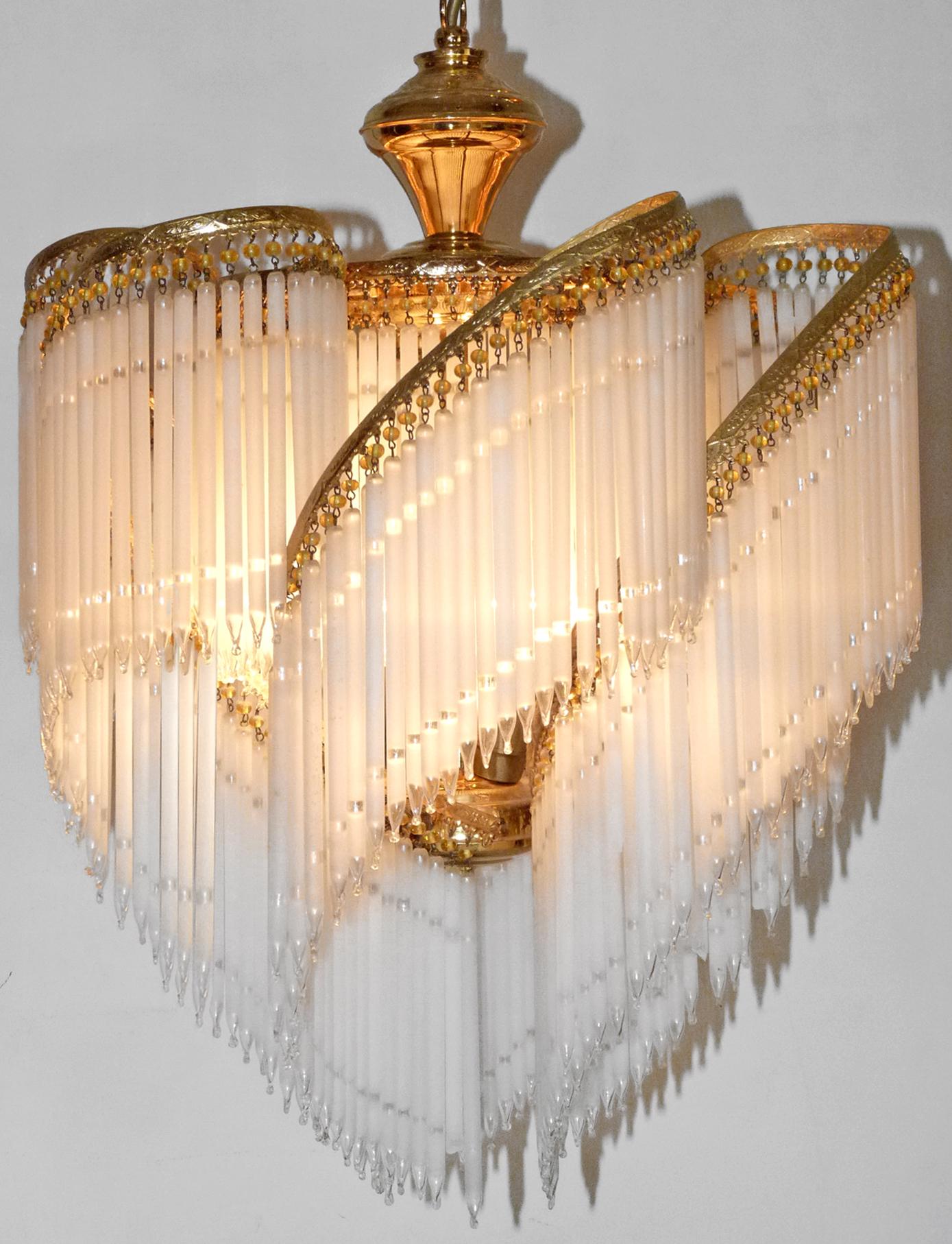 Fabulous midcentury Art Deco or Art Nouveau frosted and clear crystal glass fringe gilt spiral chandelier.
Measures:
Diameter 20 in/ 50 cm
Height 36 in/ 90 cm
Weight: 7 lb/ 6 Kg
Three light bulbs E14/ Good working condition/European