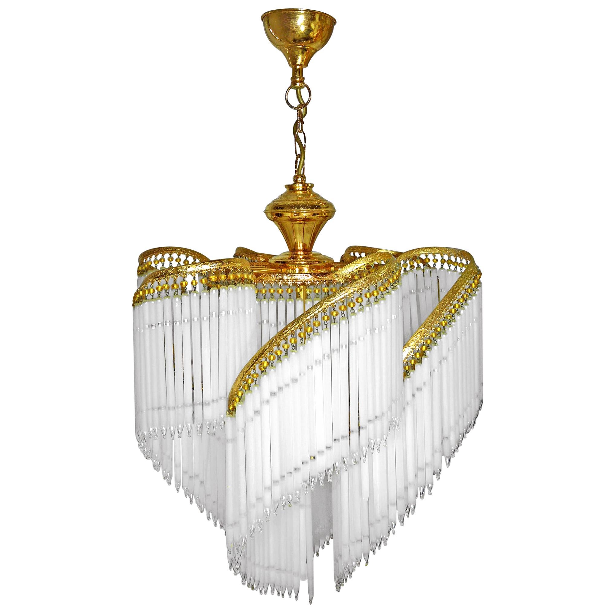 Fabulous midcentury Art Deco or Art Nouveau frosted and clear crystal glass fringe gilt spiral chandelier.
Measures:
Diameter 20 in/ 50 cm
Height 36 in/ 90 cm
Weight: 7 lb/ 6 Kg
Three light bulbs E14/ Good working condition
Assembly required.