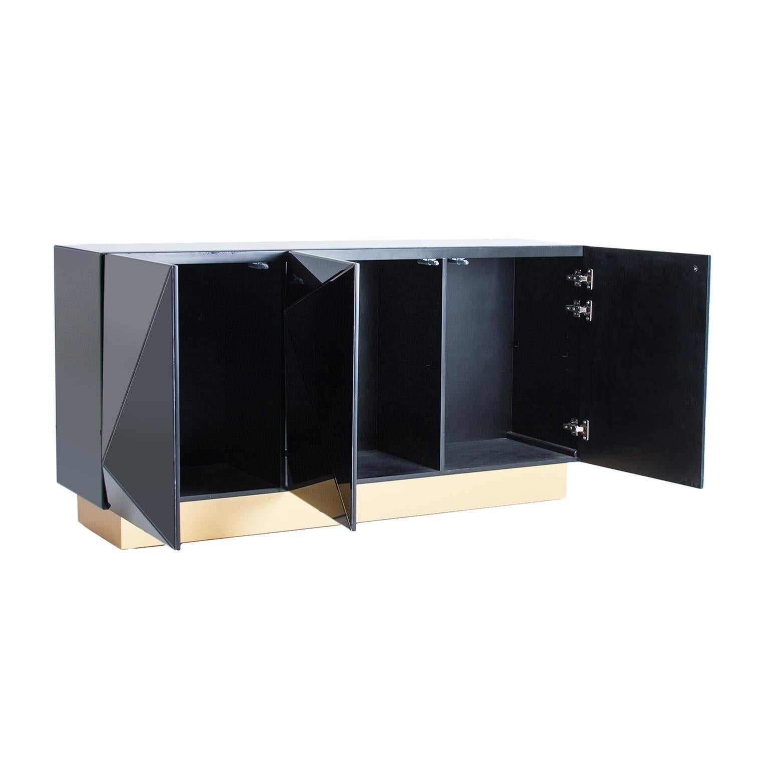 Sparkling and sophisticated black mirrored sideboard with gilded metal feet, three mirrored doors diamond and Brutalist shaped open on shelves.