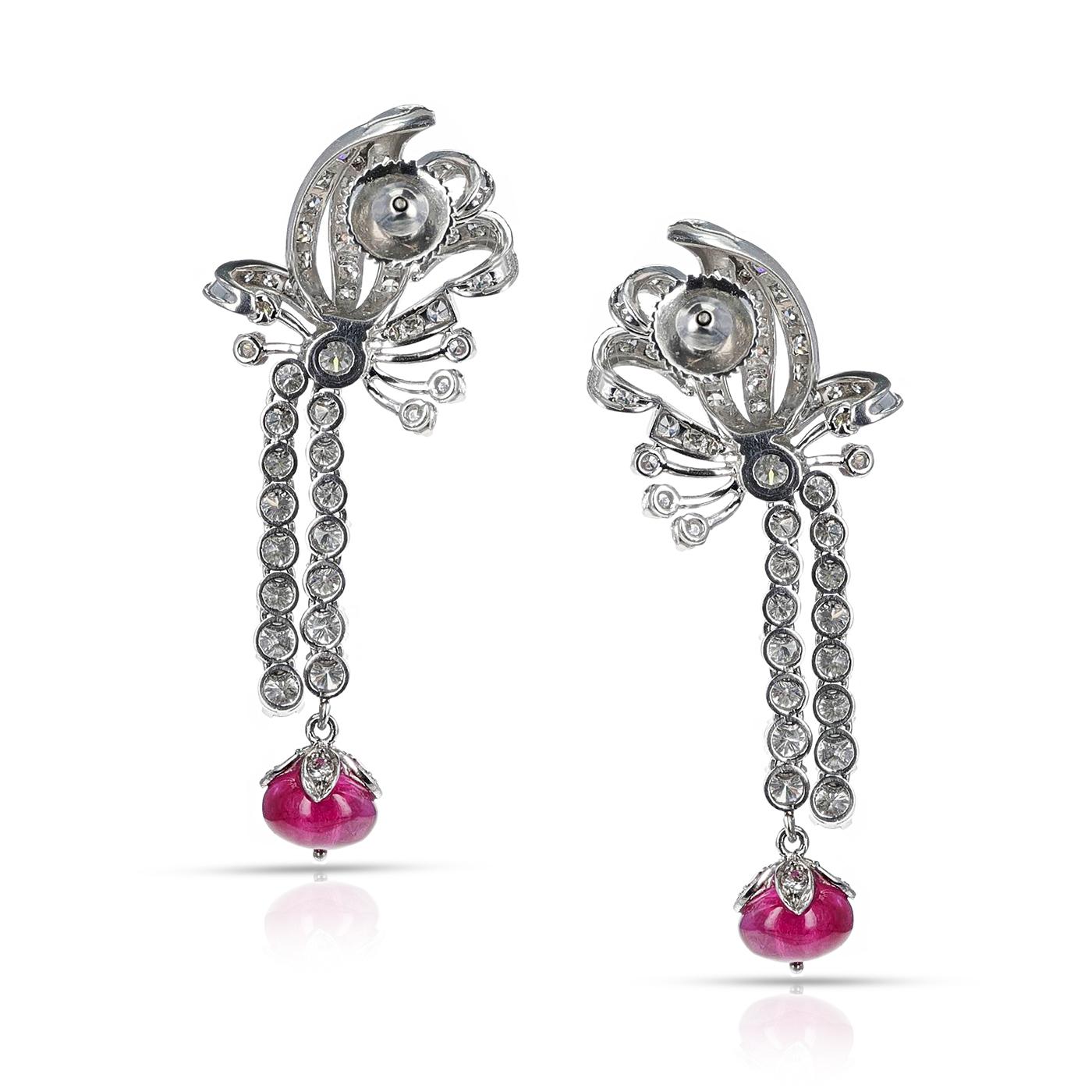 An Art Deco and Platinum Diamond Cocktail Earrings with Rubies. The weight of the diamonds is 4.50 carats and the weight of the rubies is 7 carats. The length of the earrings is 2 inches. The total weight of the earrings is 15.75 grams. 