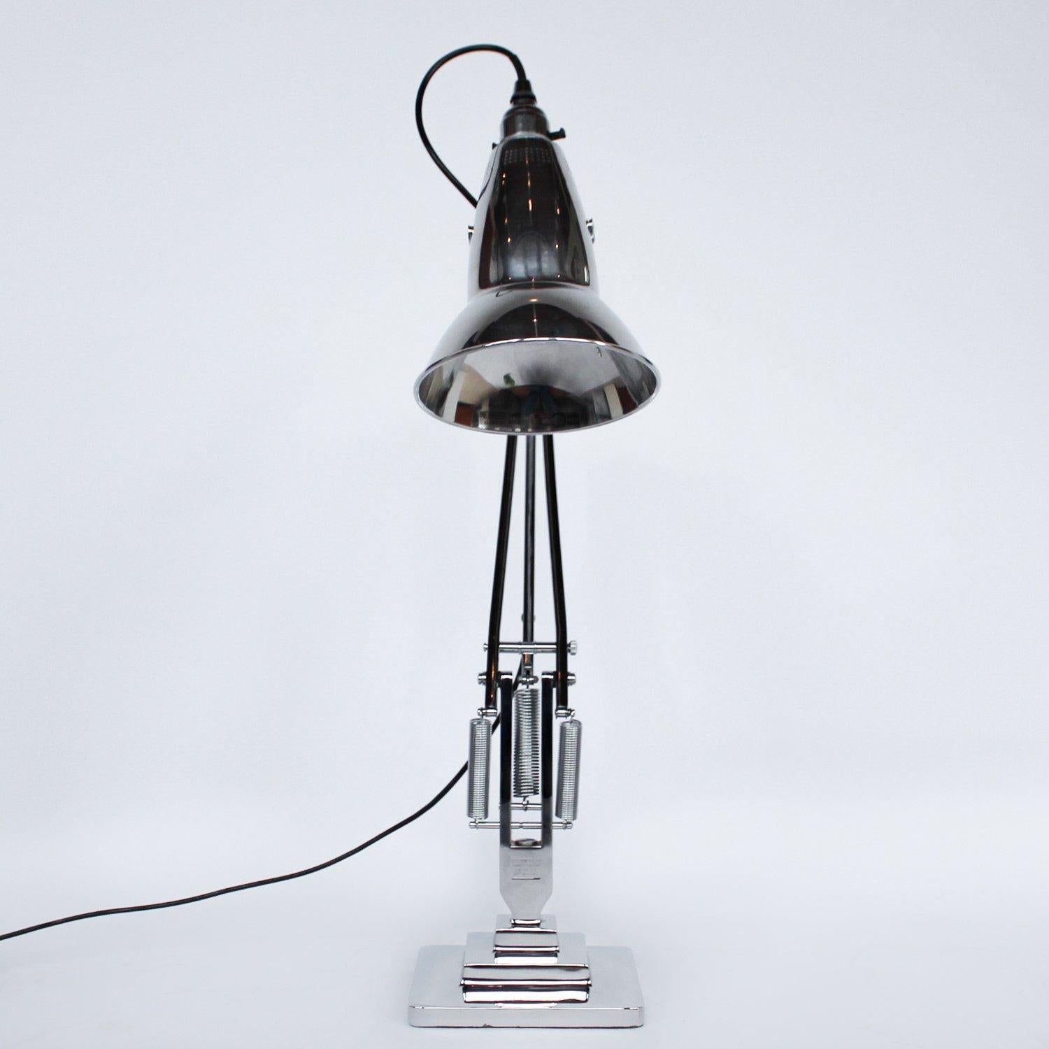 An Art Deco, 'three-spring' chromed and polished metal Anglepoise desk lamp by Herbert Terry & Sons. Three step base and perforated lamp shade. Original stamps to stem. The three spring Anglepoise lamp was first released by Herbert Terry &Sons in