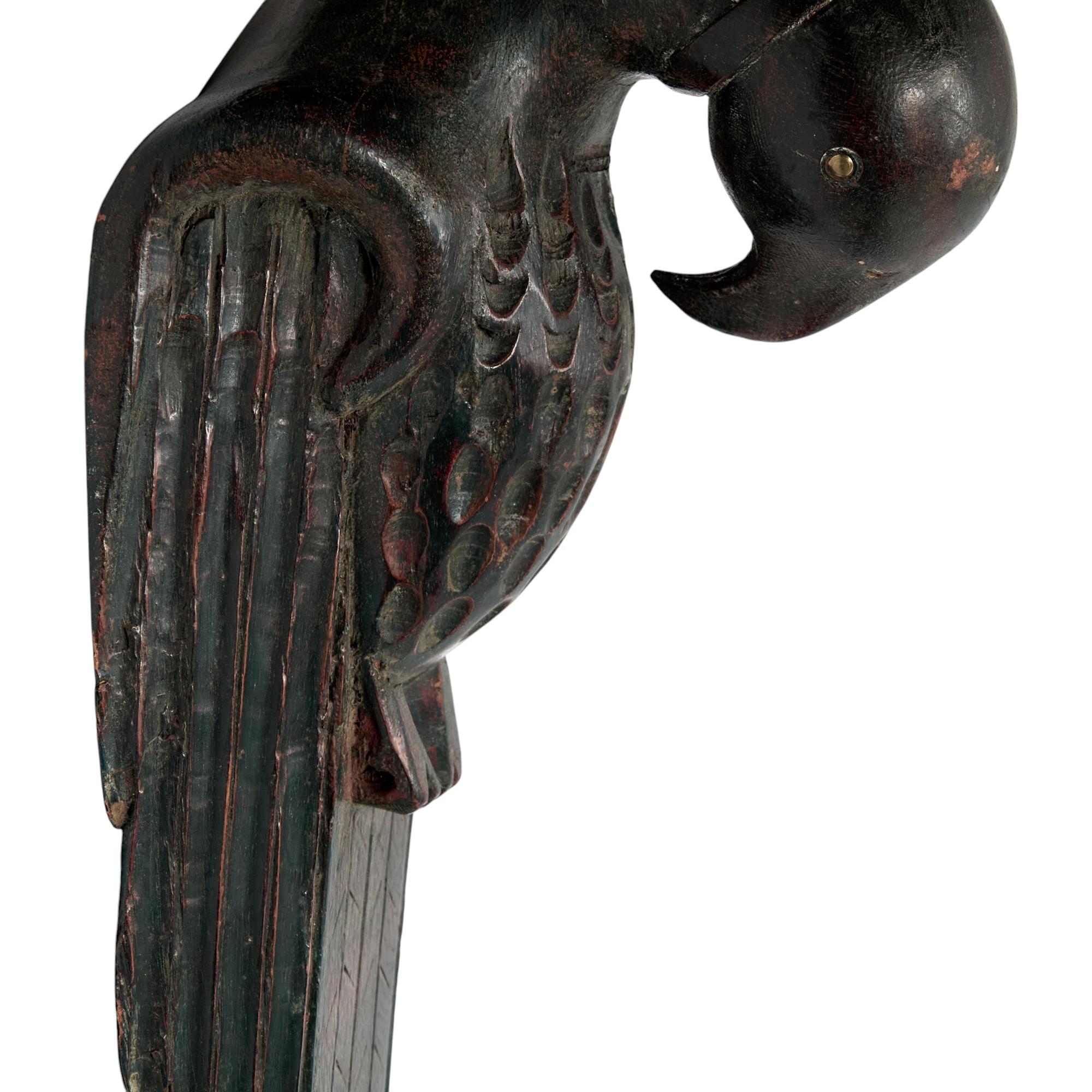 Lofty Anglo Indian art deco wall bracket with a bow front beveled shelf over a hand carved hardwood stylized bird or parrot with the original paint now worn to perfection.