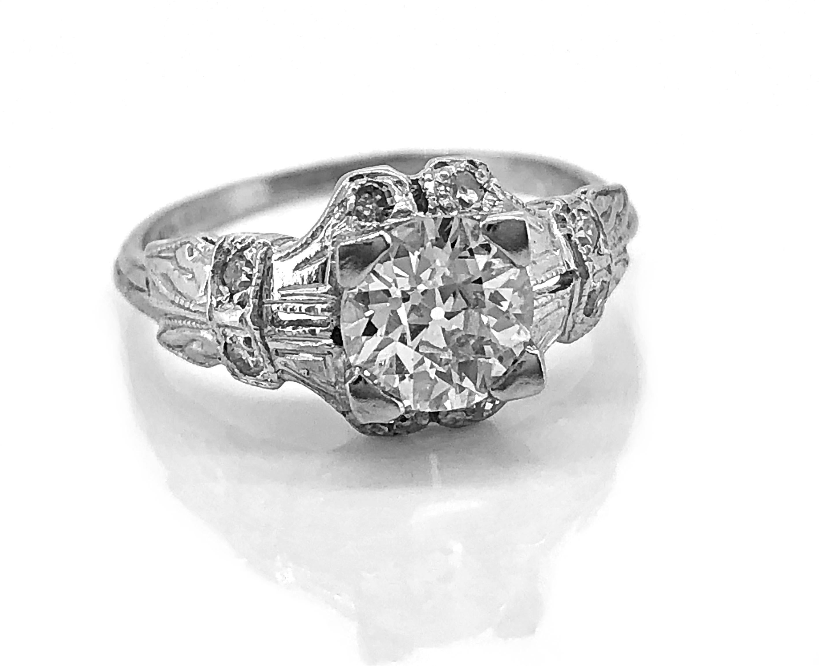 A meticulously intricate Art Deco Antique Engagement Ring featuring a .84ct. apx. European cut center diamond with SI1 clarity and G-H color. The single cut diamonds weigh .04ct. apx. T.W. and are set into this detailed platinum mounting. This is a