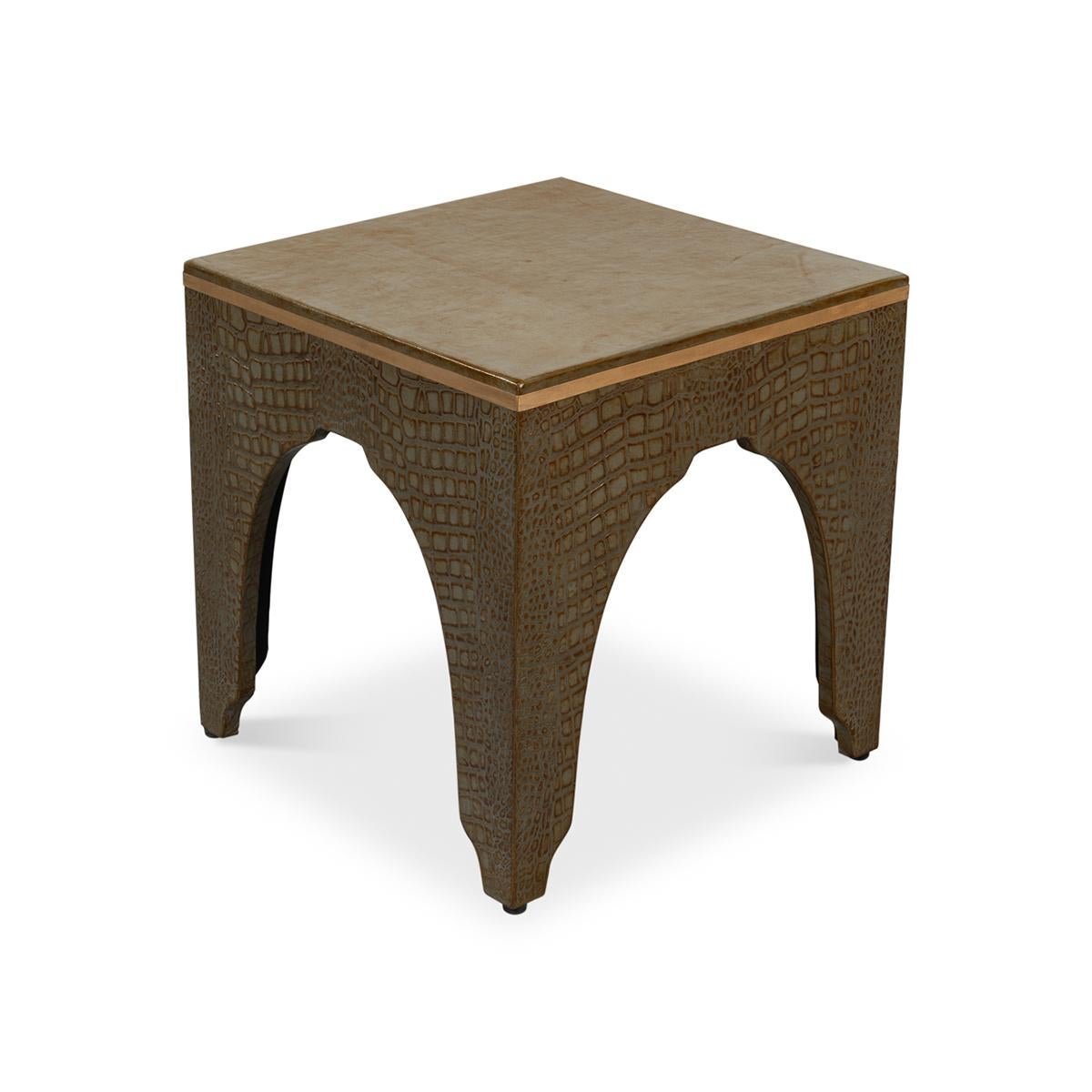 A testament to timeless elegance and luxury. Wrapped in sumptuous leather with a green embossed croc finish, this dark antique green stool exudes a refined charm that elevates any interior space.

Its sophisticated design, reflecting the grandeur of