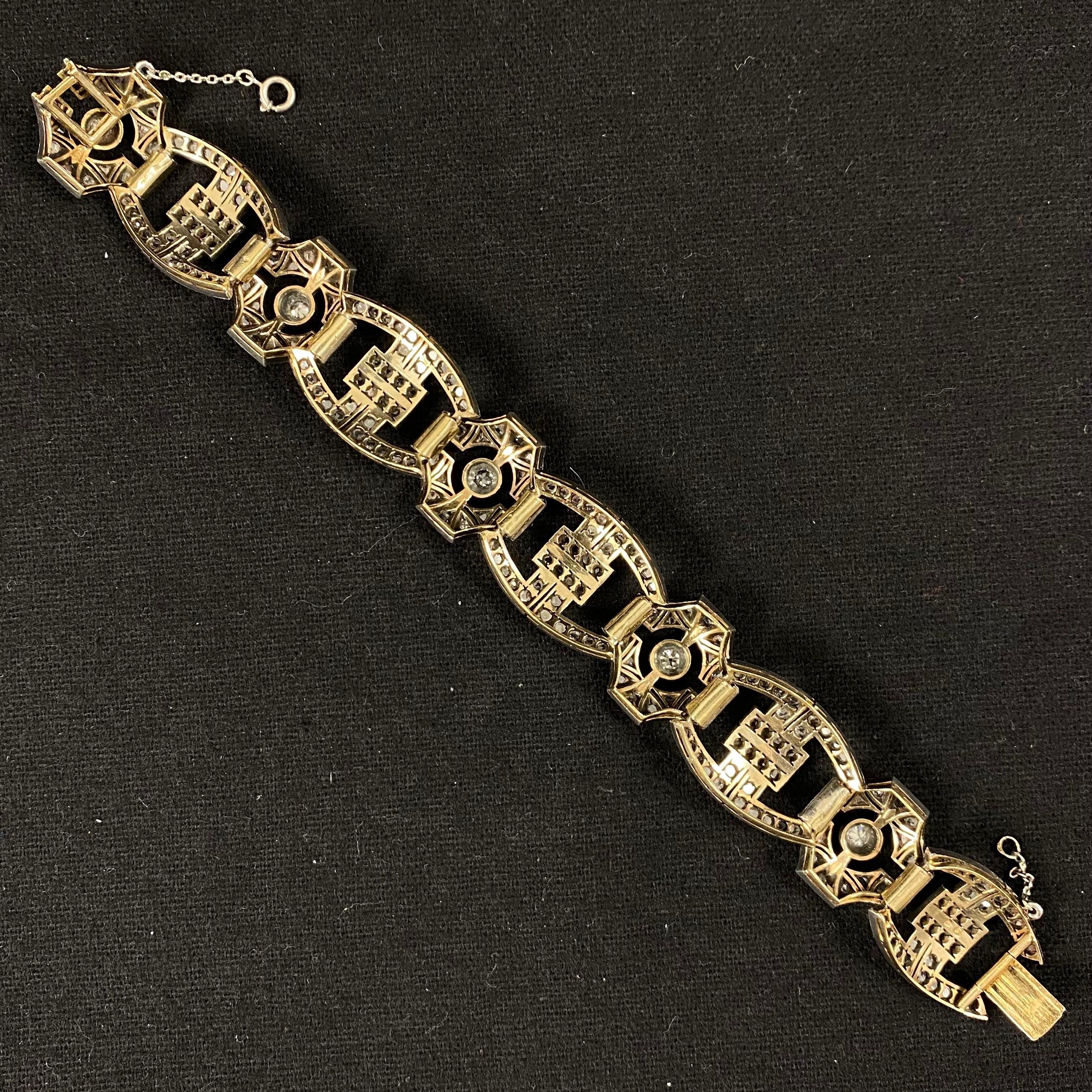 Art Deco Diamond Buckle Link Bracelet in Silver and Gold, Portugal, 1940s. Of geometric openwork design, this antique bracelet is composed of a sequence of five buckle shape links alternating with five stylized cross shape links, set throughout with