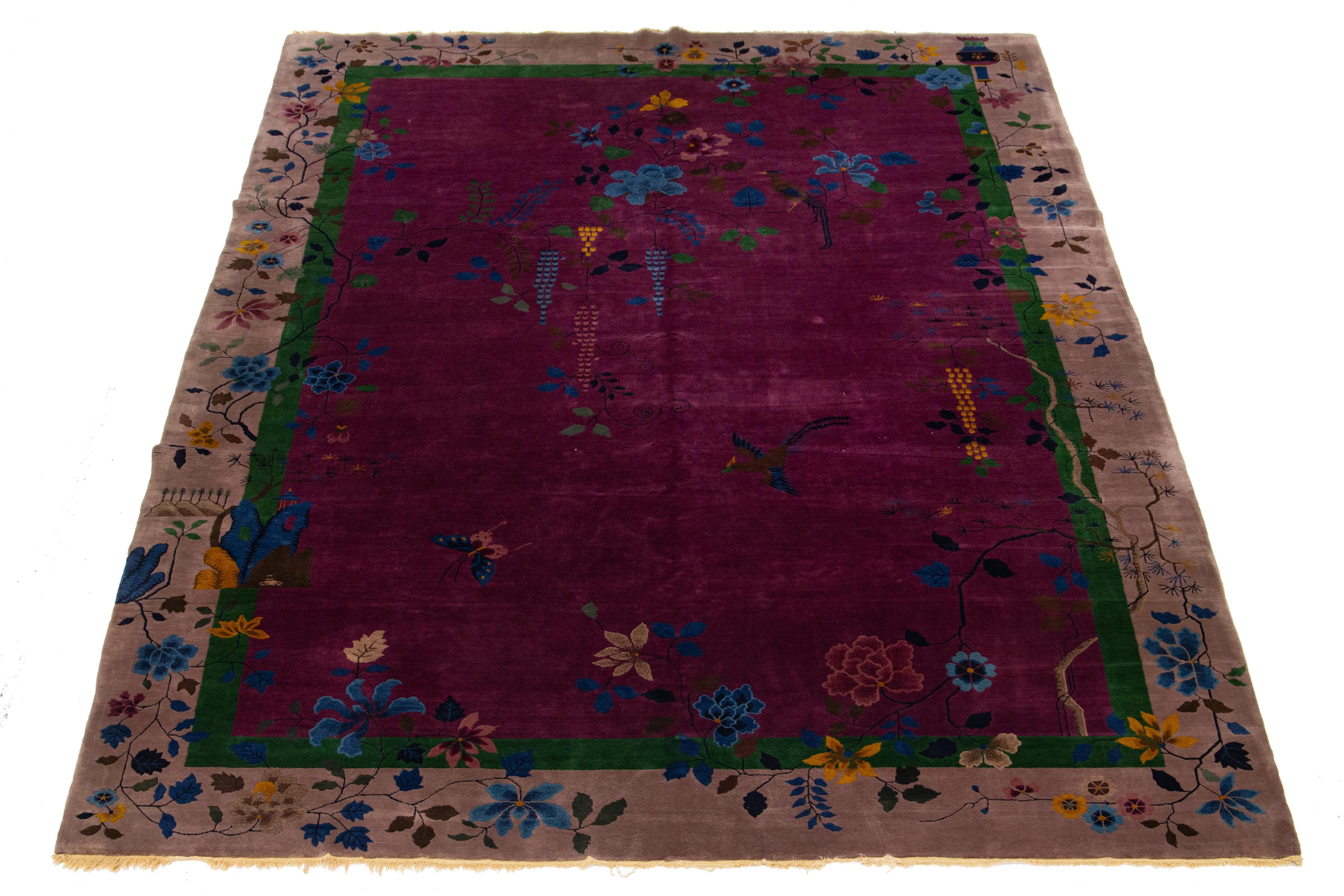 This hand-knotted wool Antique Chinese Art Deco rug features a floral design with multicolored hues on a purple background and a light purple frame.


This rug measures 10'2
