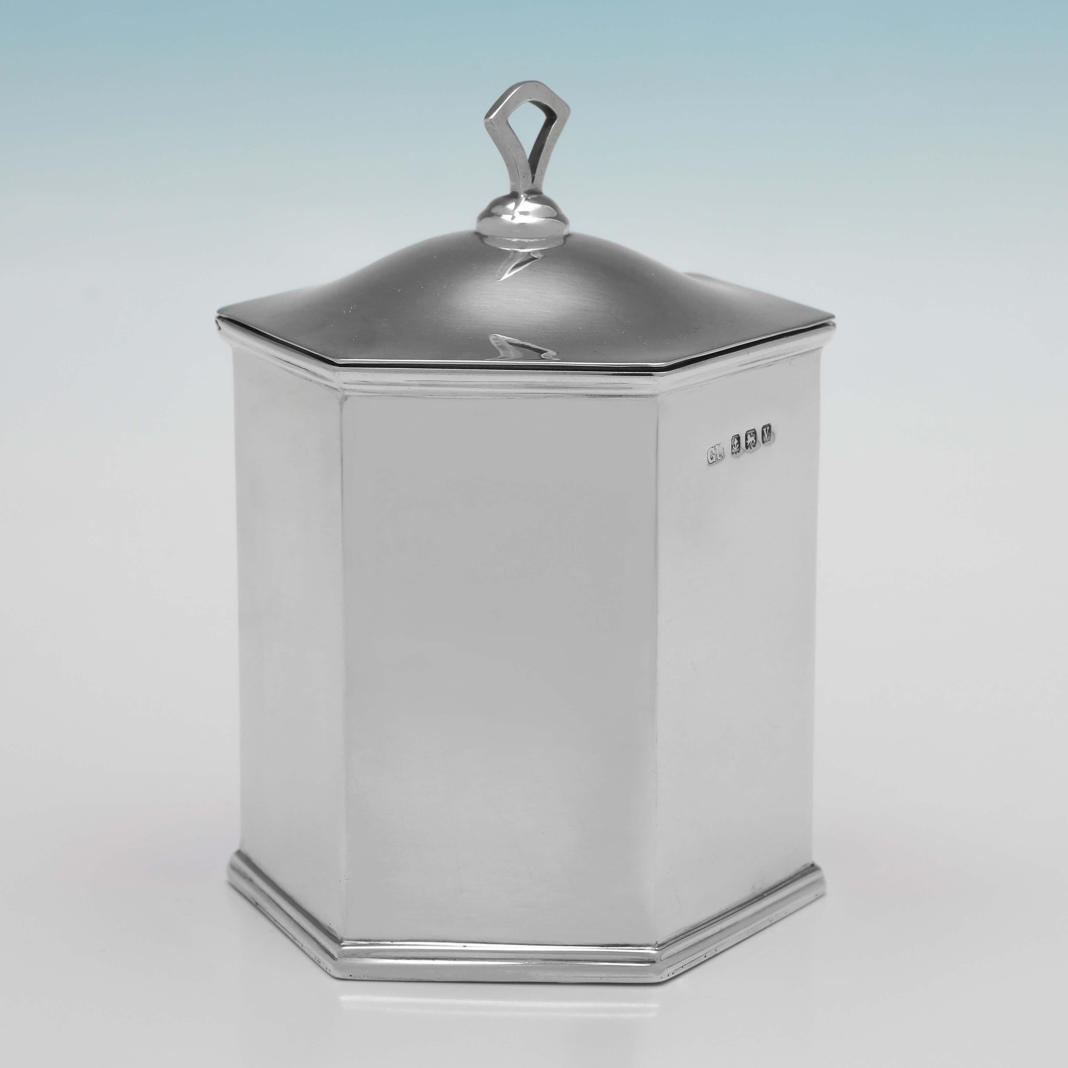 Hallmarked in Birmingham in 1920 by George Unite & Sons, this handsome, Antique Sterling Silver Tea Caddy, is hexagonal in shape, and featured reed borders, and a pull of lid. 

The tea caddy measures 4.5