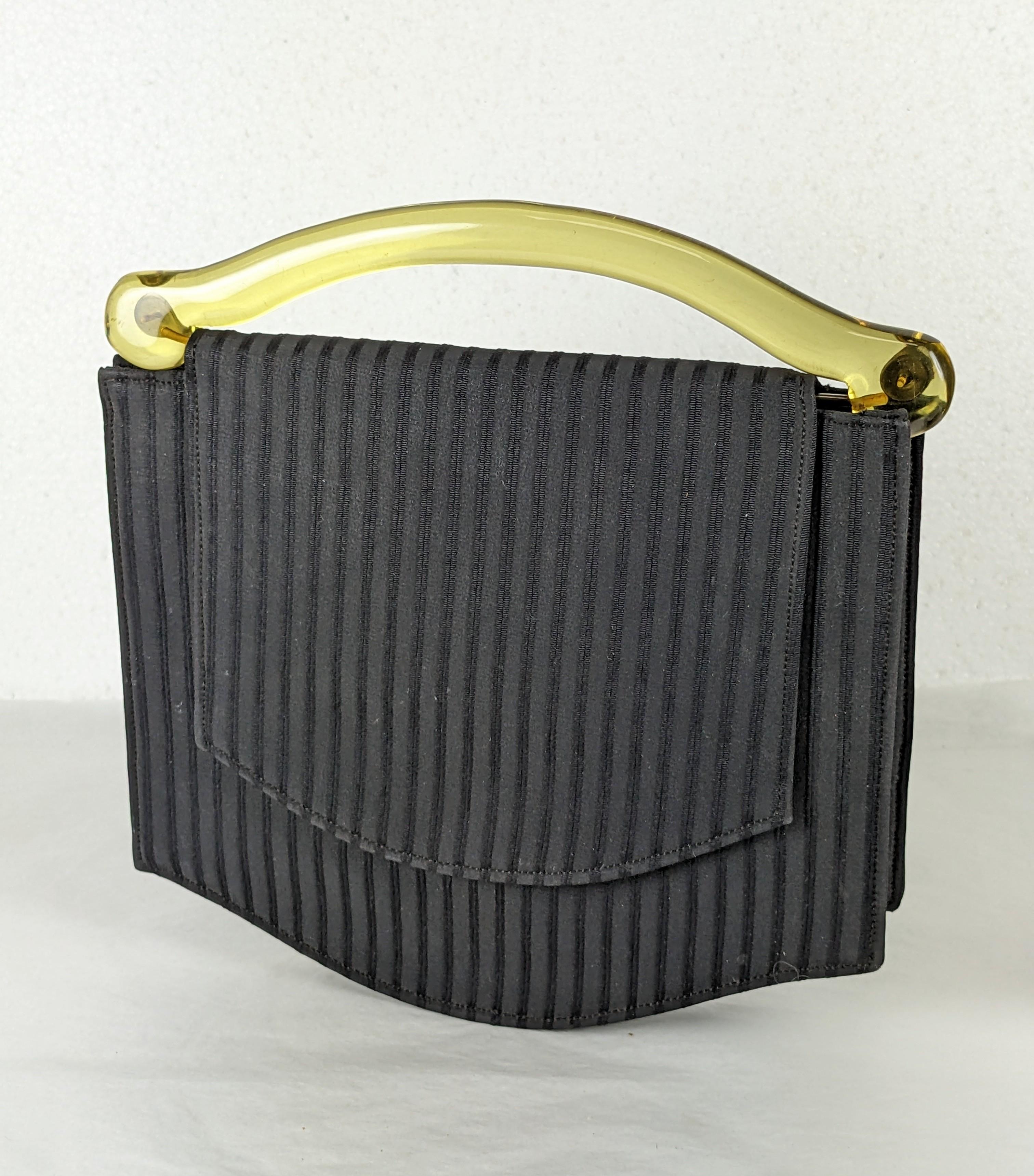 Charming Art Deco Bakelite Bag in a black ribbed cotton rayon blend. An applejuice hand carved bakelite handle is used and a snap closure keeps flap in place. 2 inside pockets and mirror. 8
