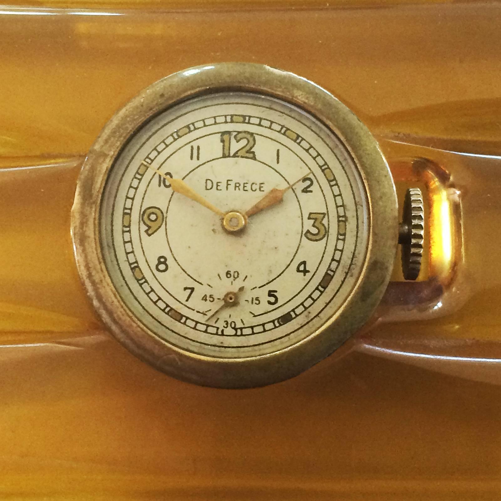 Art Deco Apple juice Coloured Bakelite Card Case fitted with Skeleton backed Watch set into the lid. The watch is by De Frece Watch Co., Inc., 48 W. 48th St., New York, imported fine Swiss made watches such as this one, in the 1930’s and 1940’s. It