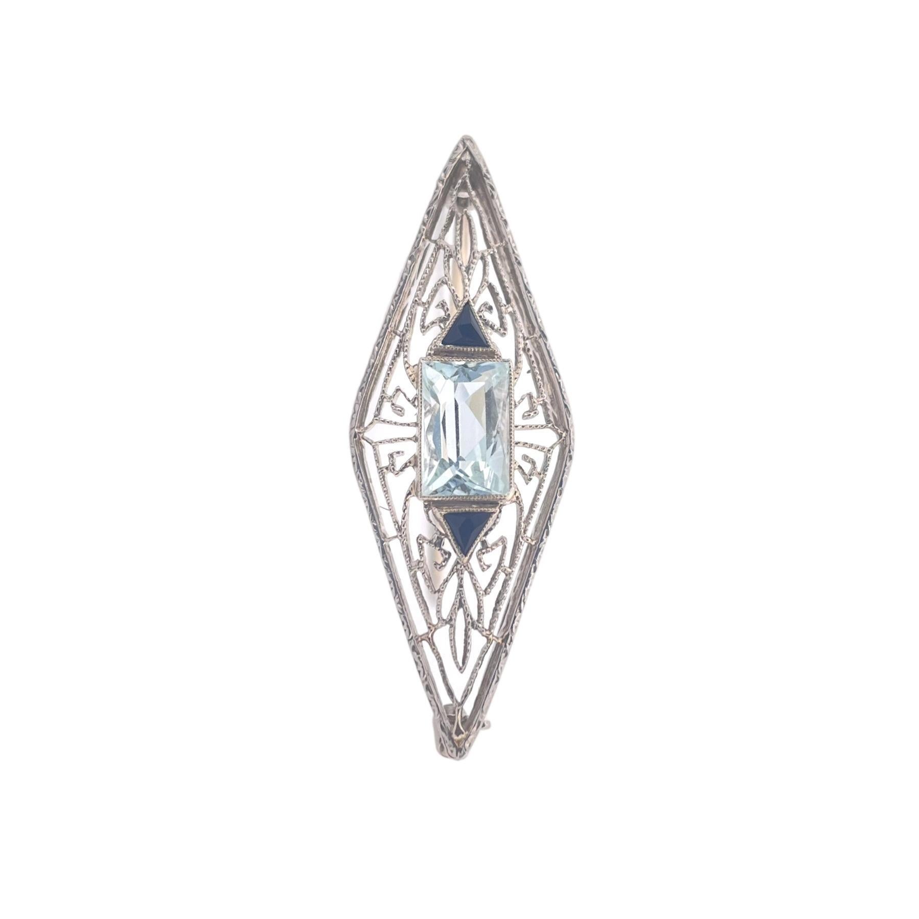 Elevate your jewelry collection with this exquisite Art Deco Aqua and Onyx Brooch, a vintage masterpiece that captures the essence of the Art Deco era. Crafted in lustrous 14K white gold and adorned with aqua and onyx gemstones, this brooch is a