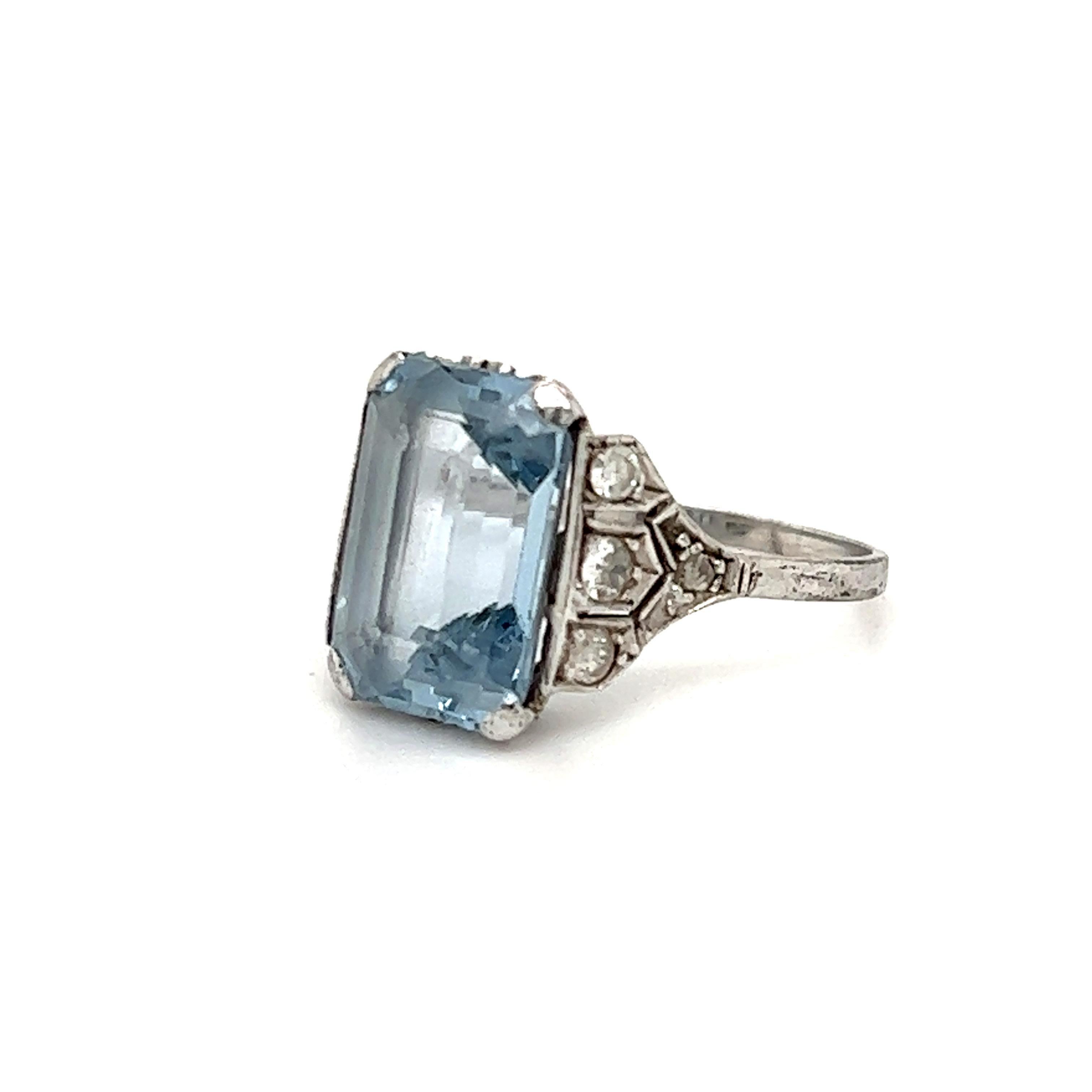 Beautiful art deco ring, This elegant ring highlights one aqua marine gemstone in a emerald cut shape. The aqua marine gemstone displays a beautiful blue color that contrasts beautifully against the platinum and diamond accents. This ring shows