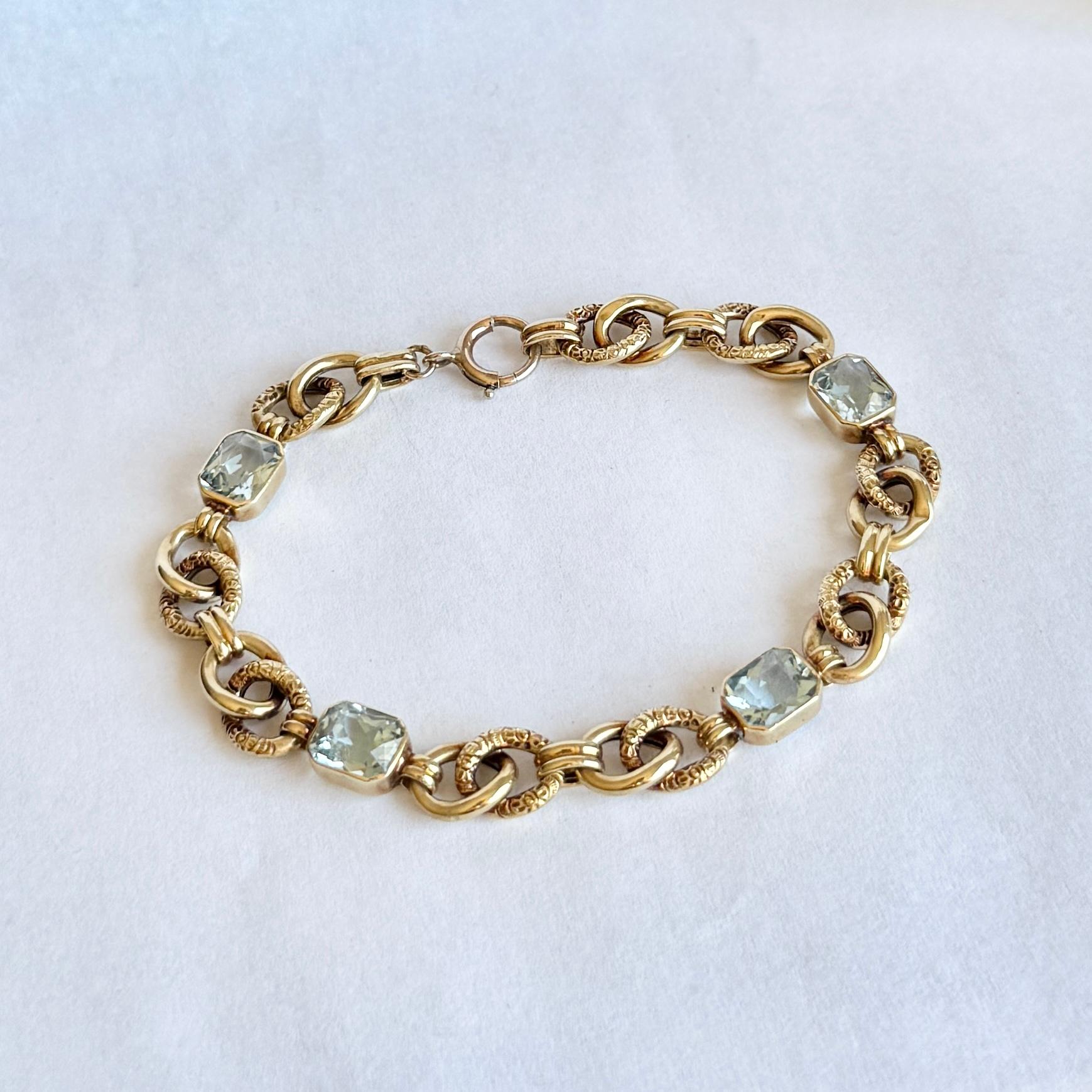This sweet bracelet holds a total of four aquamarine stones each measuring approx 1.2ct. The bracelet is modelled in 14ct gold. 

Length: 20cm
Width: 9mm

Weight: 11.3g