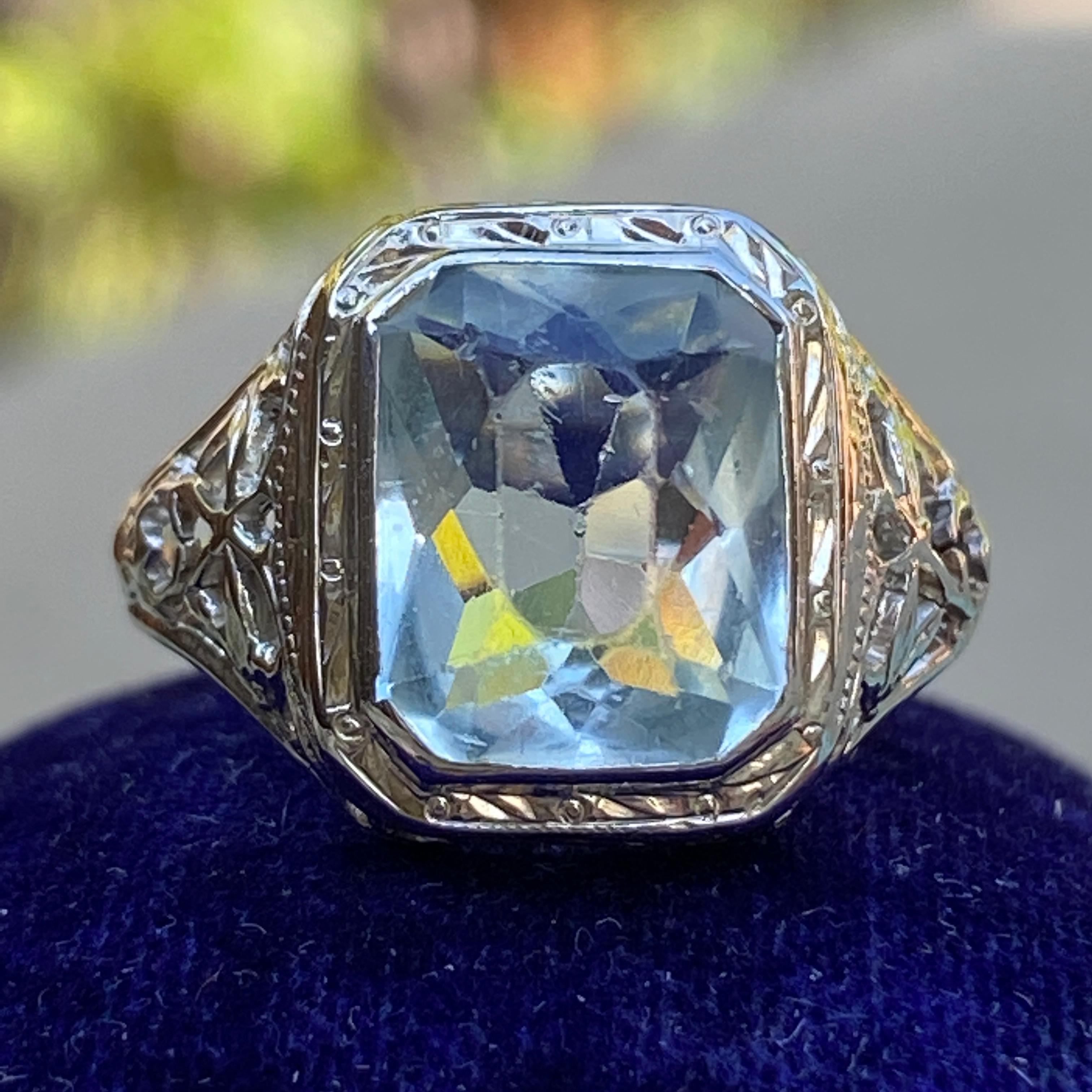 Details:
Stunning 14K white gold filigree, aquamarine ring—with tiny yellow gold ribbons surrounding the setting! The aquamarine measures 13.25mm x 6mm, with a classic beautiful light blue color. The height of the aqua at the center of the setting