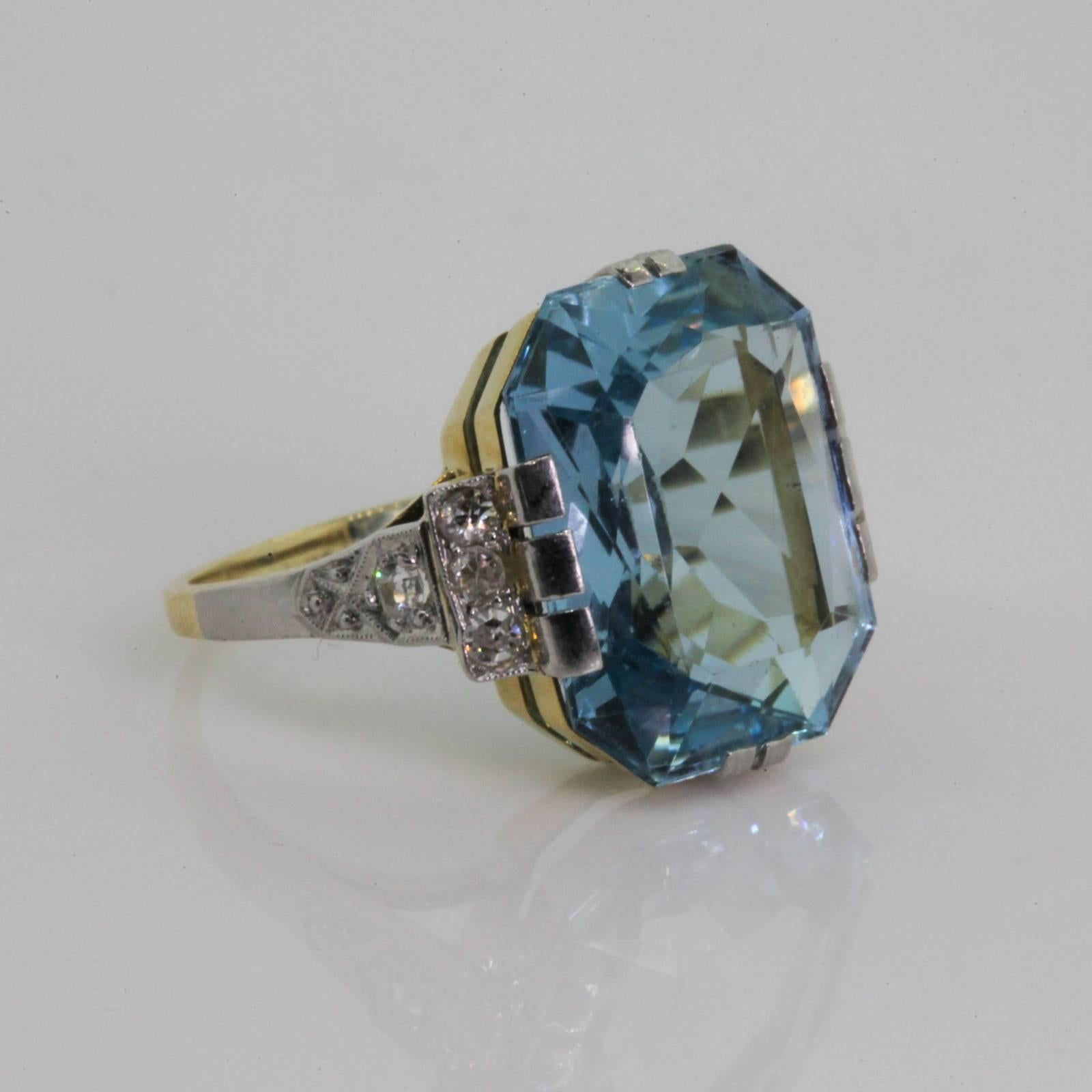 This unique 1930s era ring features a beautiful cut corner emerald cut Aquamarine,  weighing approx. 8.00 carat.   The faceted Aqua is embraced by platinum prongs and flanked by six old cut diamonds, weighing a total of approx. 0.18 carat.  The 14KT