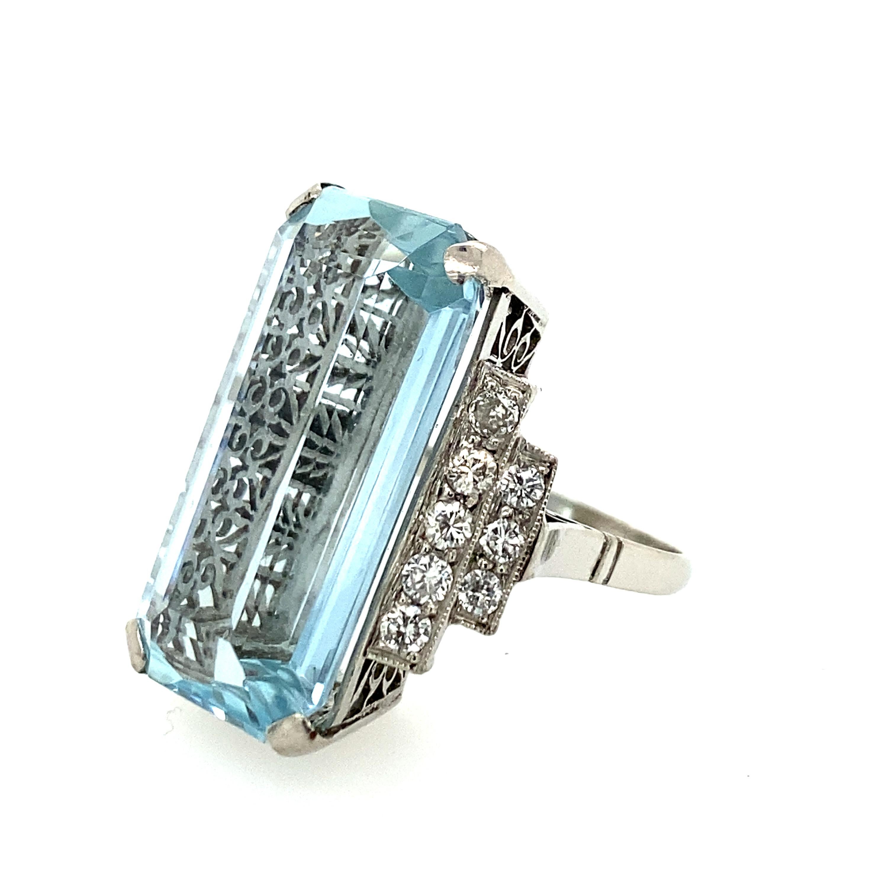 Art Deco Style aquamarine and diamond ring with .85cts of brilliant diamonds surrounding the center stone. The aquamarine measures 25.00x12.18mm and is set in platinum.