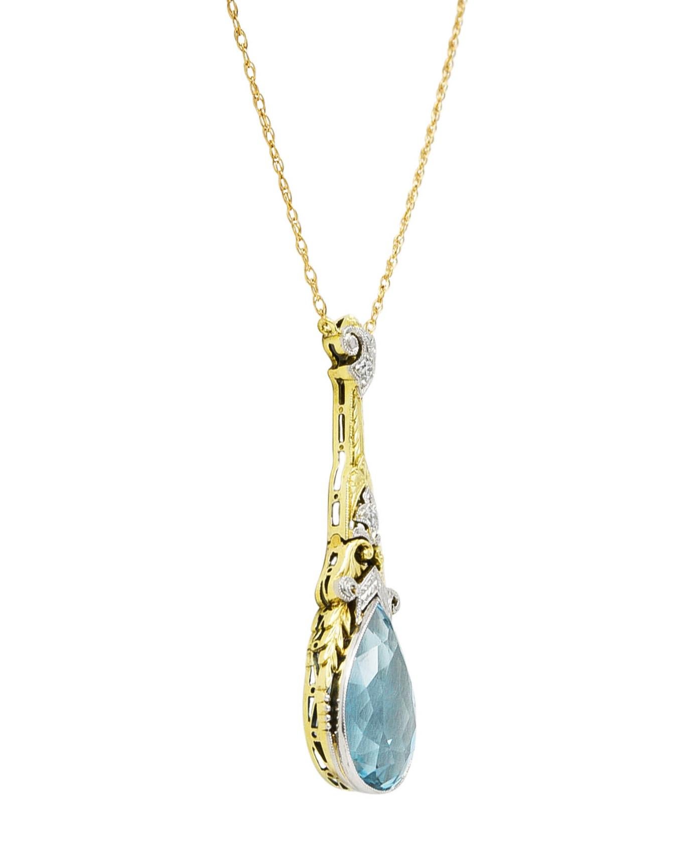 Designed as a spiga link chain with a central station featuring a pear cut aquamarine. Weighing approximately 5.53 carats total - transparent light blue in color. Set in a platinum bezel with an ornate gold wheat motif surround. With pierced scroll