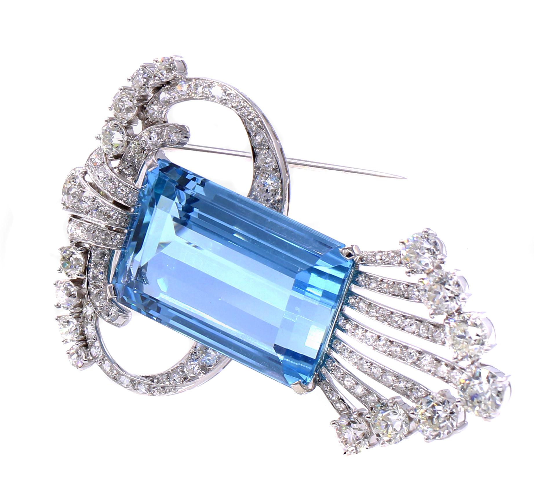 A gorgeous Santa Maria blue rectangular step cut aquamarine weighing 46.30 carats in the center piece of this magnificent Art Deco clip-brooch/pendant necklace. Embellished by Old European Cut diamonds weighing approximately 7 carats this wonderful