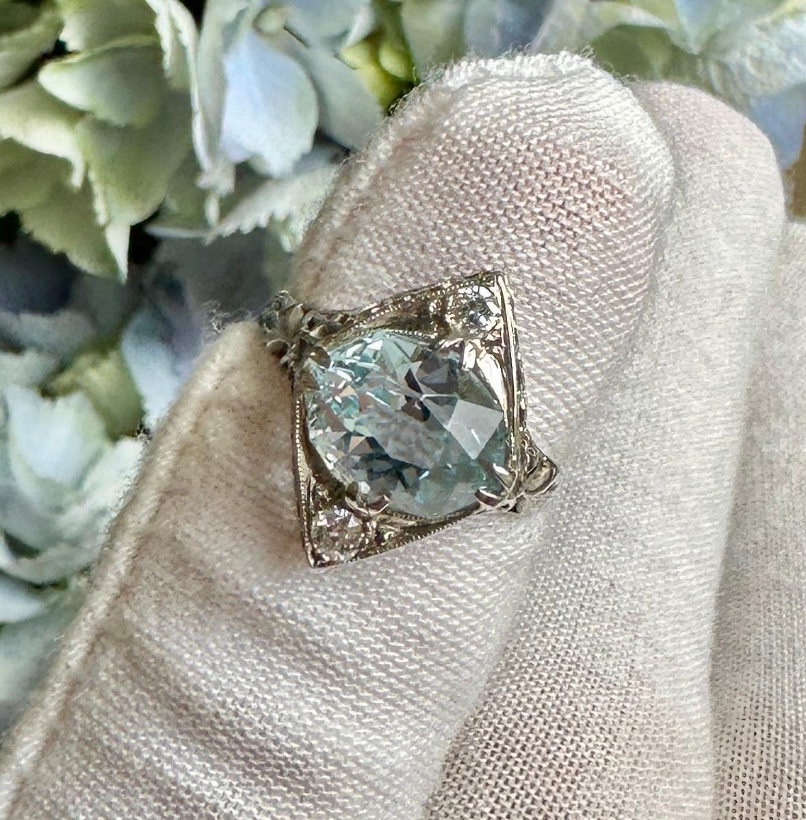 This is a stunning antique Art Deco 2.6 Carat Aquamarine and Old Mine Cut Diamond Ring in an 18 Karat White Gold filigree open work setting of great beauty.  The Engagement Ring, Wedding Ring or fashion ring is centered by a gorgeous Oval Faceted