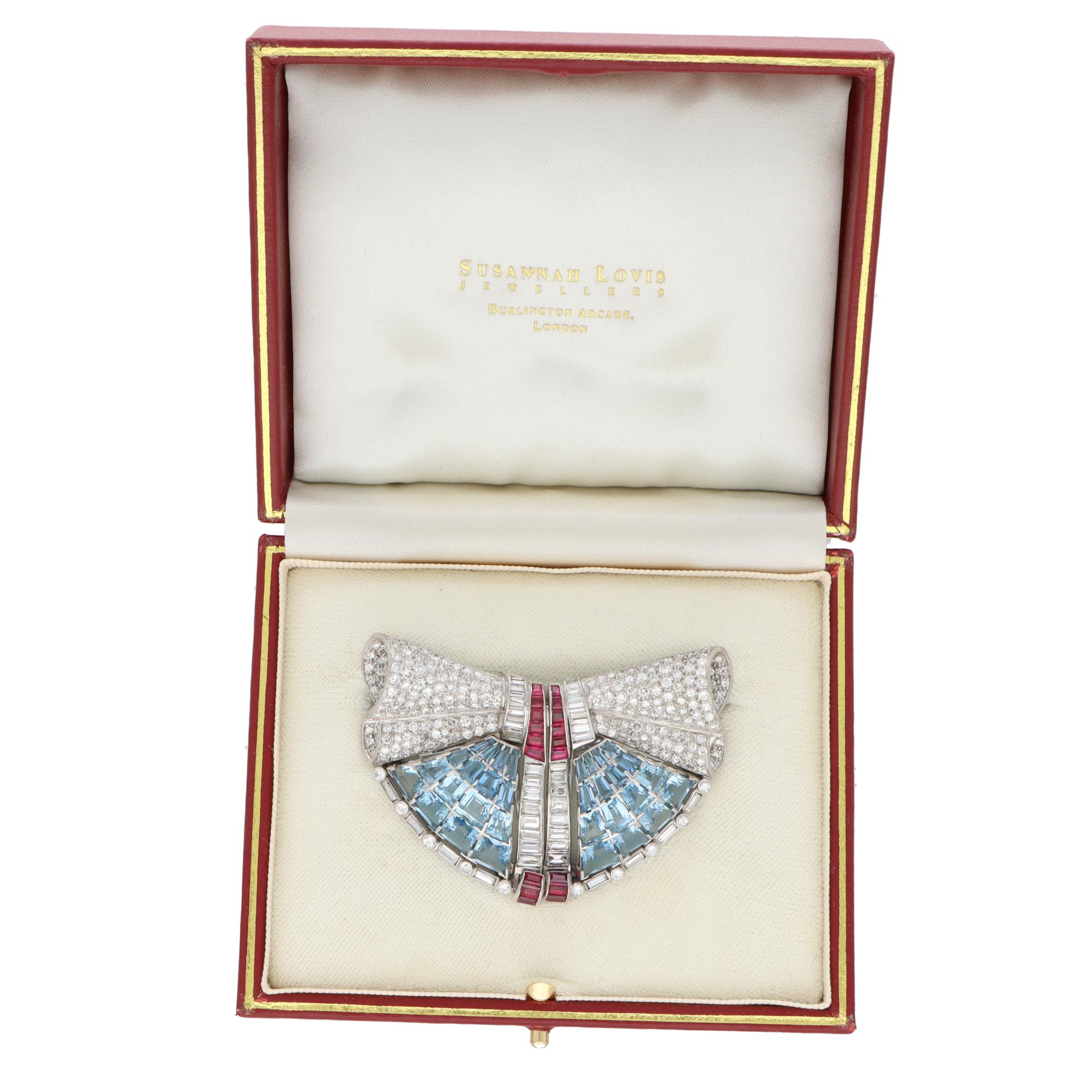  A beautiful Art Deco aquamarine, ruby and diamond double clip convertible brooch set in platinum.

The brooch depicts a bow motif and is set with approximately 310 individual stones. The top of the bow is pave set with transitional and round