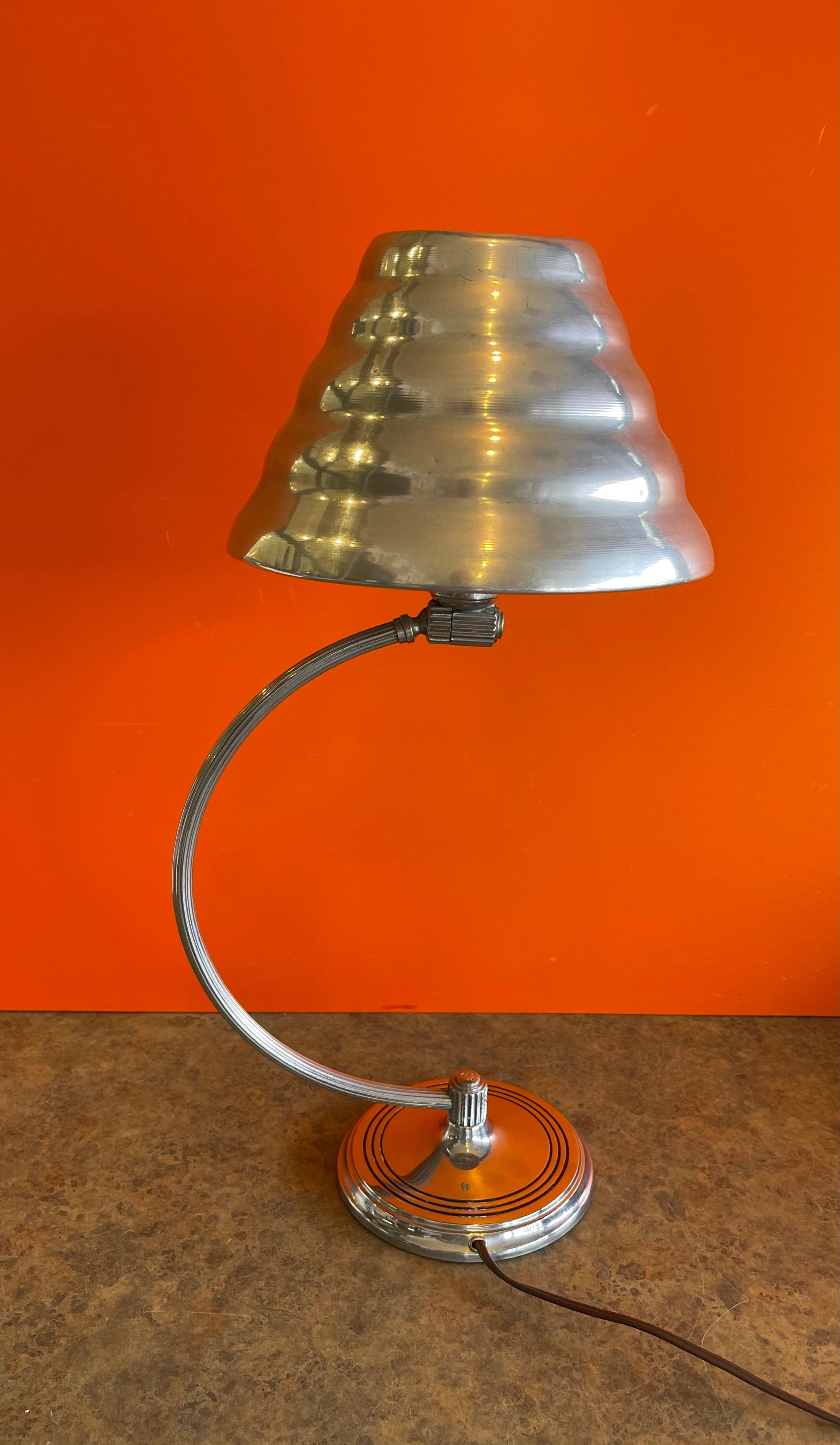 Art Deco arc desk lamp with rare tin shade by Chase & Co., circa 1930s. The lamp is in very good working condition and measure 6
