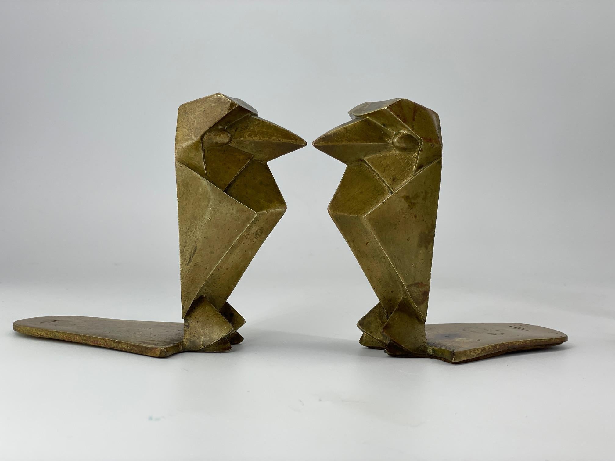Pair of brass American Art Deco Bird bookends designed in sharply geometric patterns, like metropolis architectural elements of the 1920-1940.   Each bird is stamped 