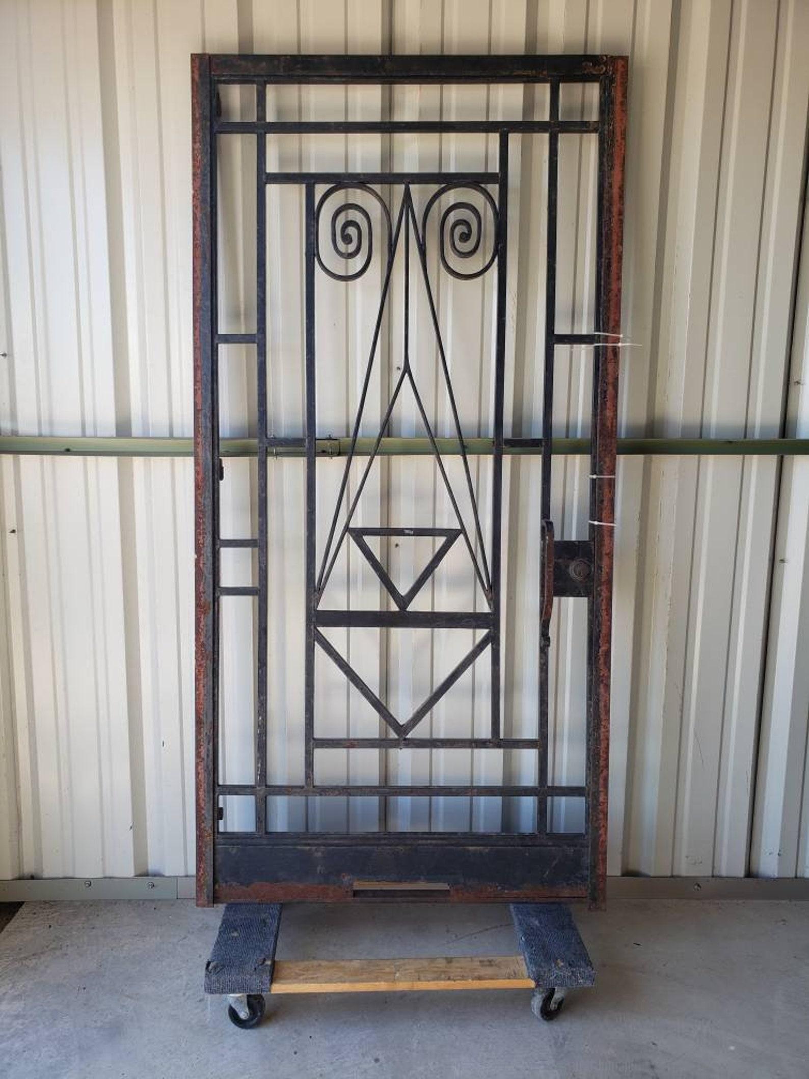 A magnificent, period, custom, one of a kind, European Art Deco gated door frame from the early 20th century. 

The heavy, hand forged wrought iron architectural salvage masterpiece featuring sculptural spiral scroll, angular, geometric motif. The