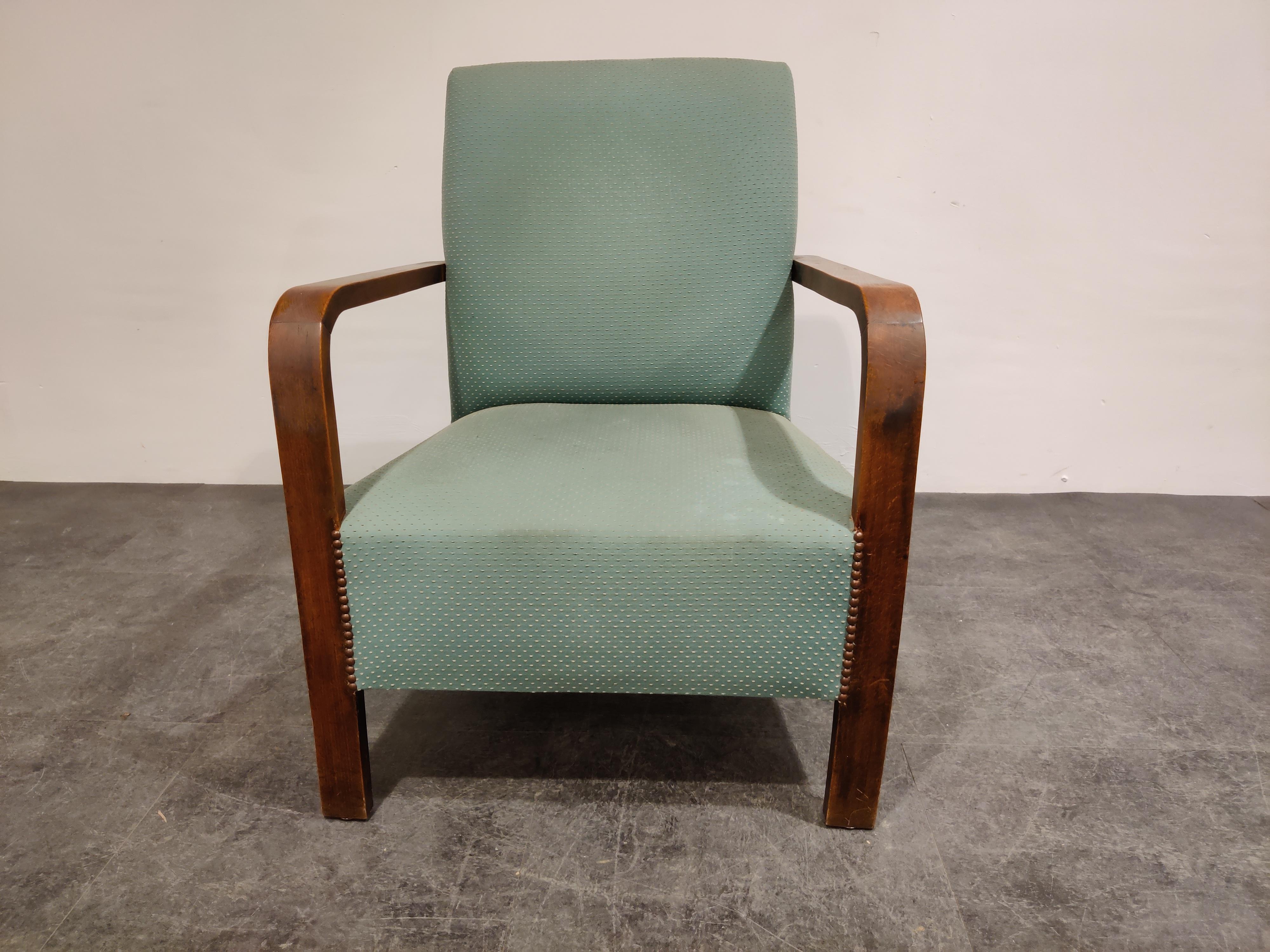 Elegant Art Deco armchair with original green fabric.

Typical Art Deco era design

Good condition, minor staining on the fabric.

Very comfy chair. 

1930s - Belgium

Dimensions: 
Height 85cm/33.46