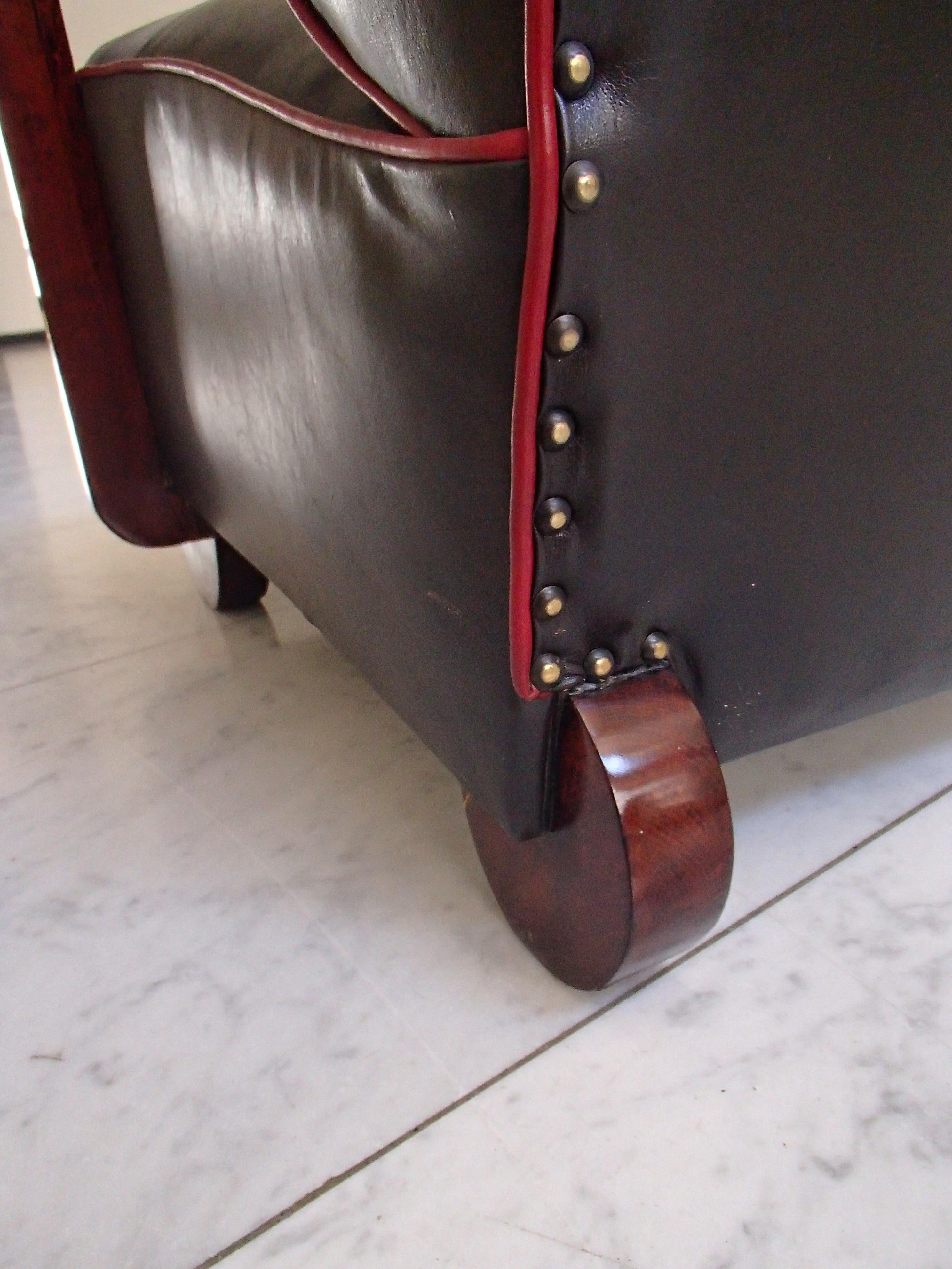 Art Deco armchair blackbrown leather with red tinted birch.