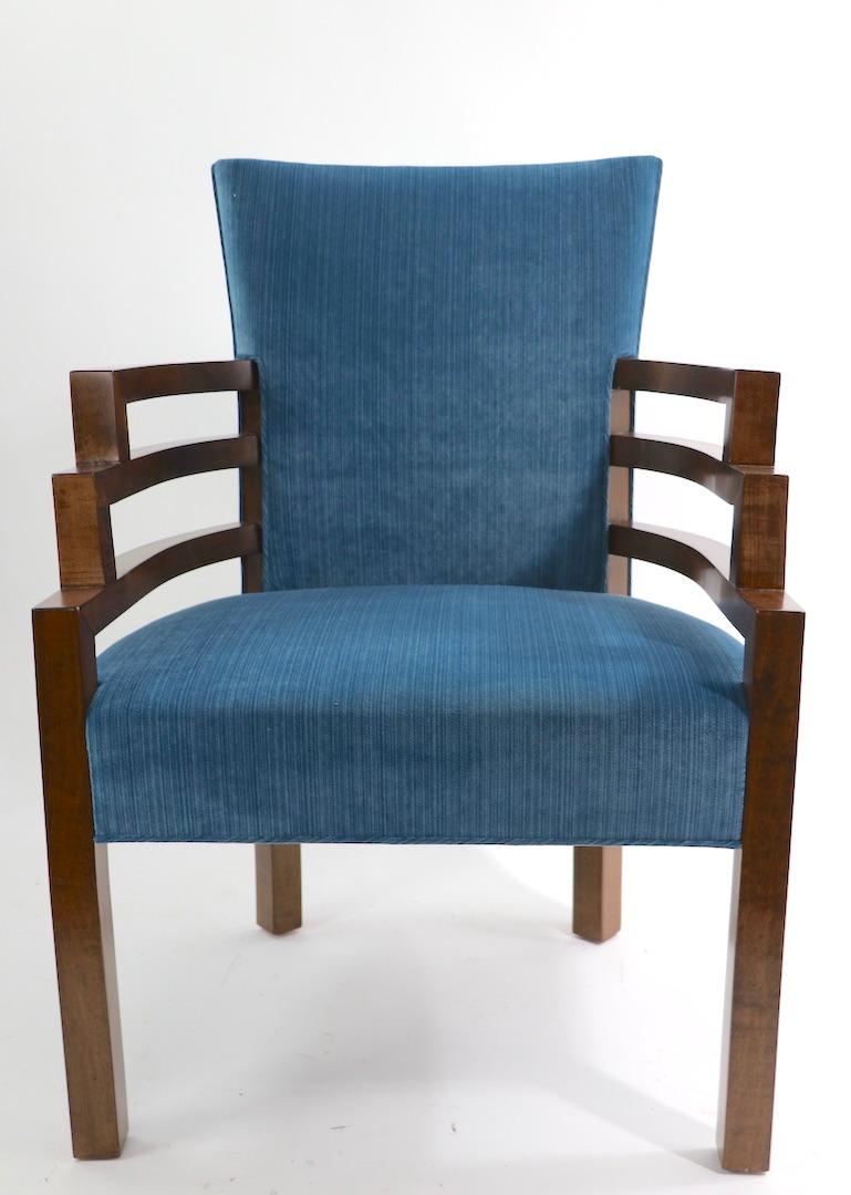 Iconic Art Deco armchair, design attributed to Kem Weber. Stepped profile arms, of solid wood, upholstered seat and backrest. This example has been professionally restored, wood refinished, and reupholstered. Exceptional example of early modern,