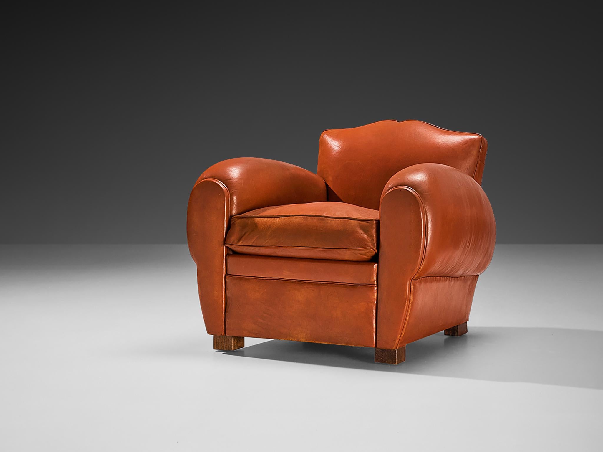 Maurice Rinck, lounge chair, reddish brown leather, beech, France, 1940s

Grand and comfortable club chair in leather upholstery. Truly extraordinary and luxurious chair that features a deep seat and large rounded, curved armrests. The backrests are