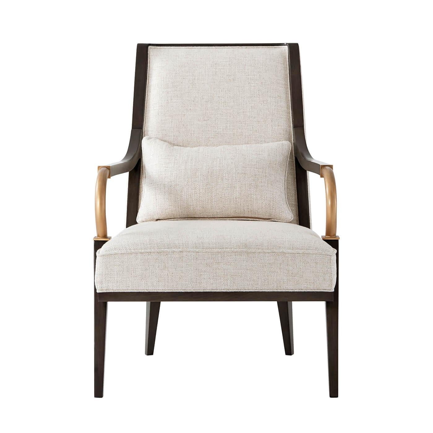 A fine French Art Deco-inspired open armchair with a curved and padded backrest, down swept arms with bronze finish terminals, a boxed seat, and kidney pillow above square tapered and angled legs.

Dimensions: 26.75