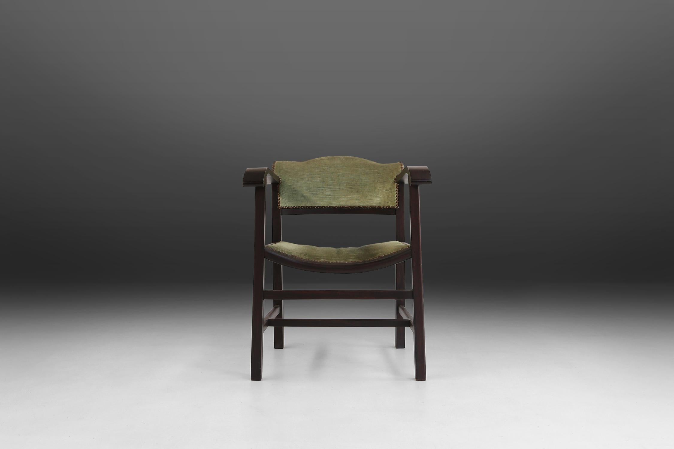 Art Deco armchair made of black painted wood and green fabric.
Made around 1930 in Belgium. Has some nice details in brass buttons.