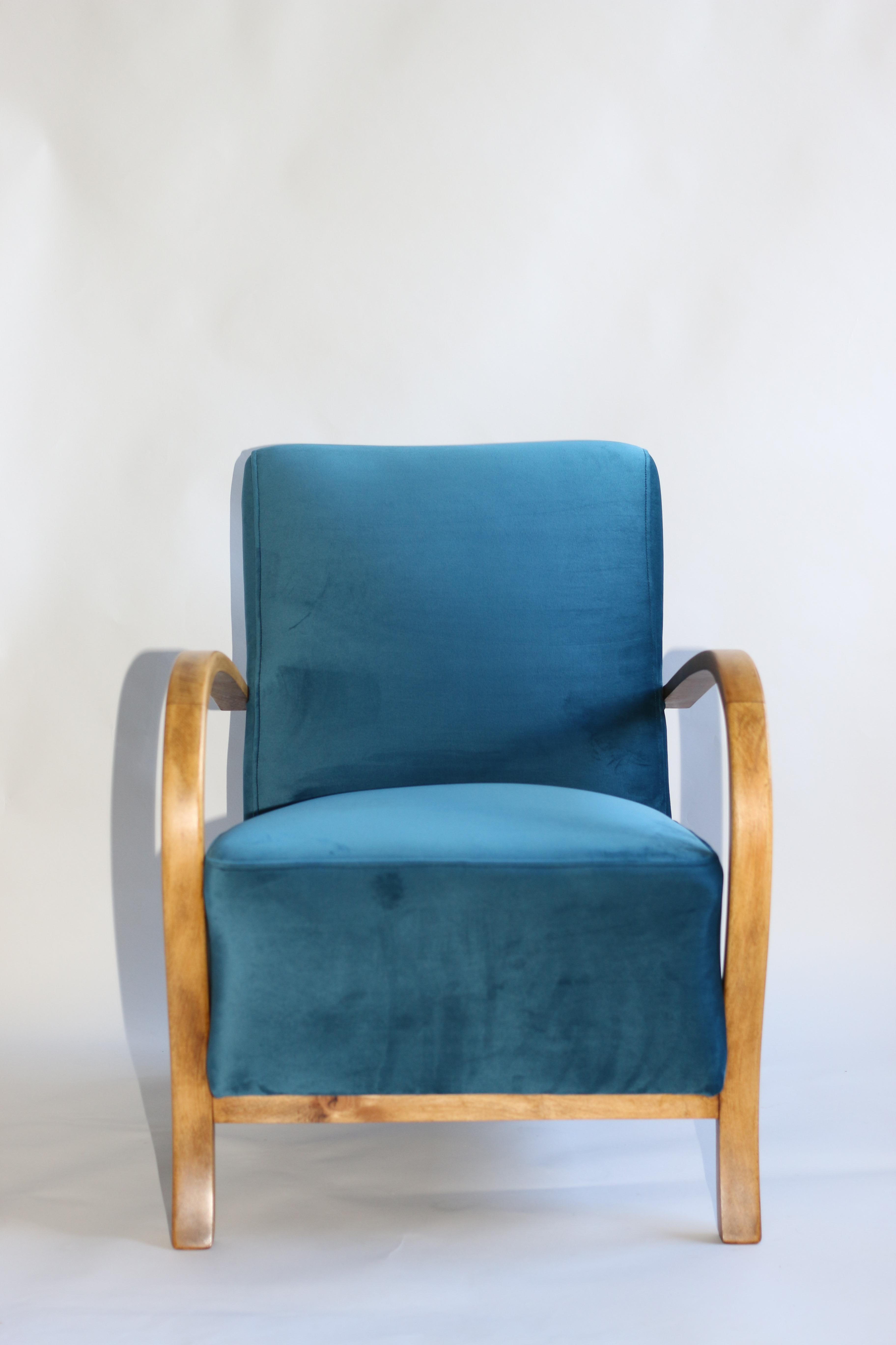 Restored Art Deco armchair in blue marine velvet from 1960s, new upholstery covered with velvet fabric in fashionable blue color, finished with wooden chair cushion. Wooden elements in antic wood color and beech tree. Perfect