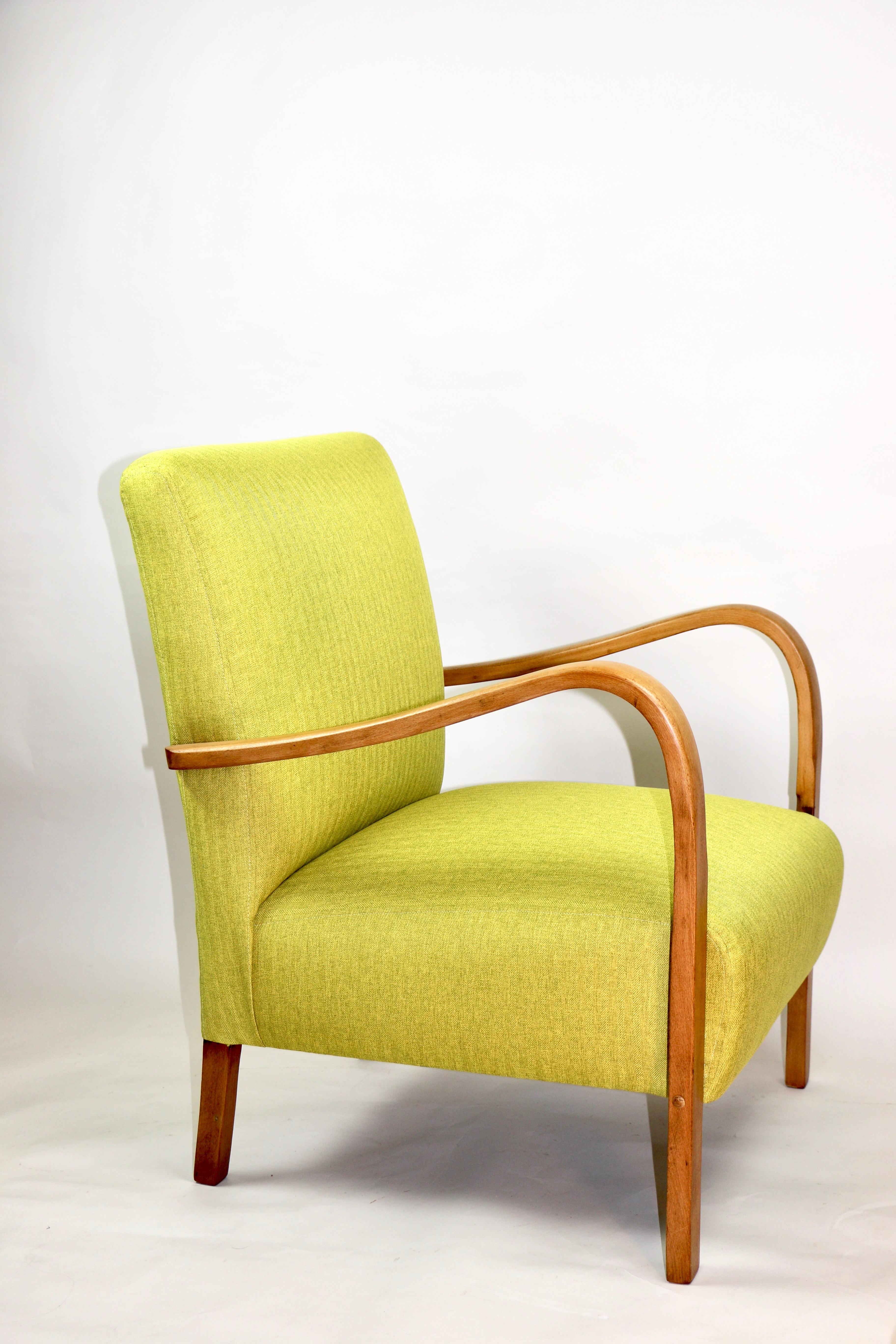 Restored Art Deco armchair in yellow from 1960s, new upholstery covered with herringbone fabric in fashionable yellow color, finished with wooden chair cushion. Wooden elements in american wood color and beech tree. Very good