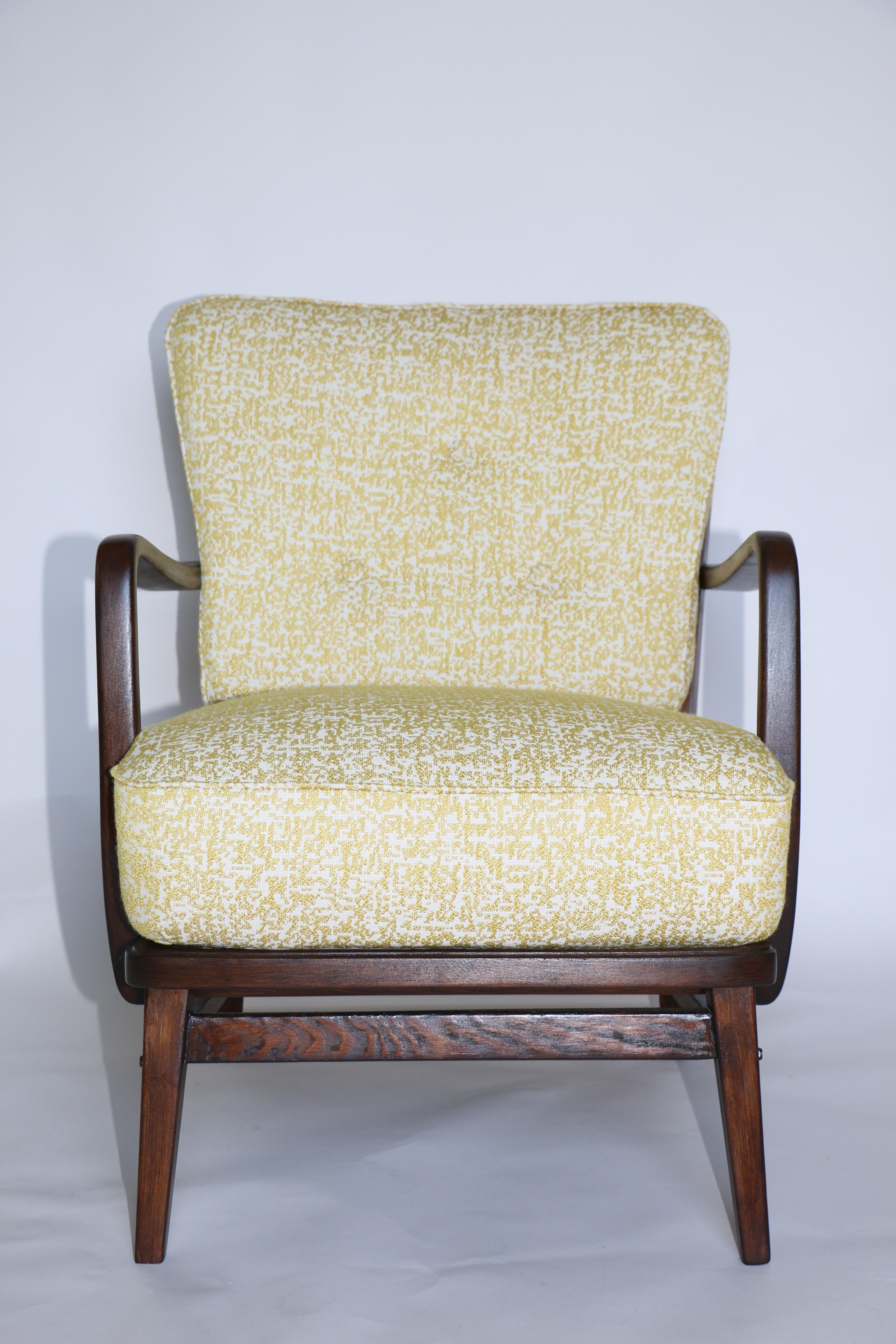 Restored Art Deco armchair in yellow fabric from 1970s, new upholstery covered with natural fabric in fashionable mix of yellow and white color, finished with wooden chair cushion. Wooden elements in dark antic wood color. Perfect