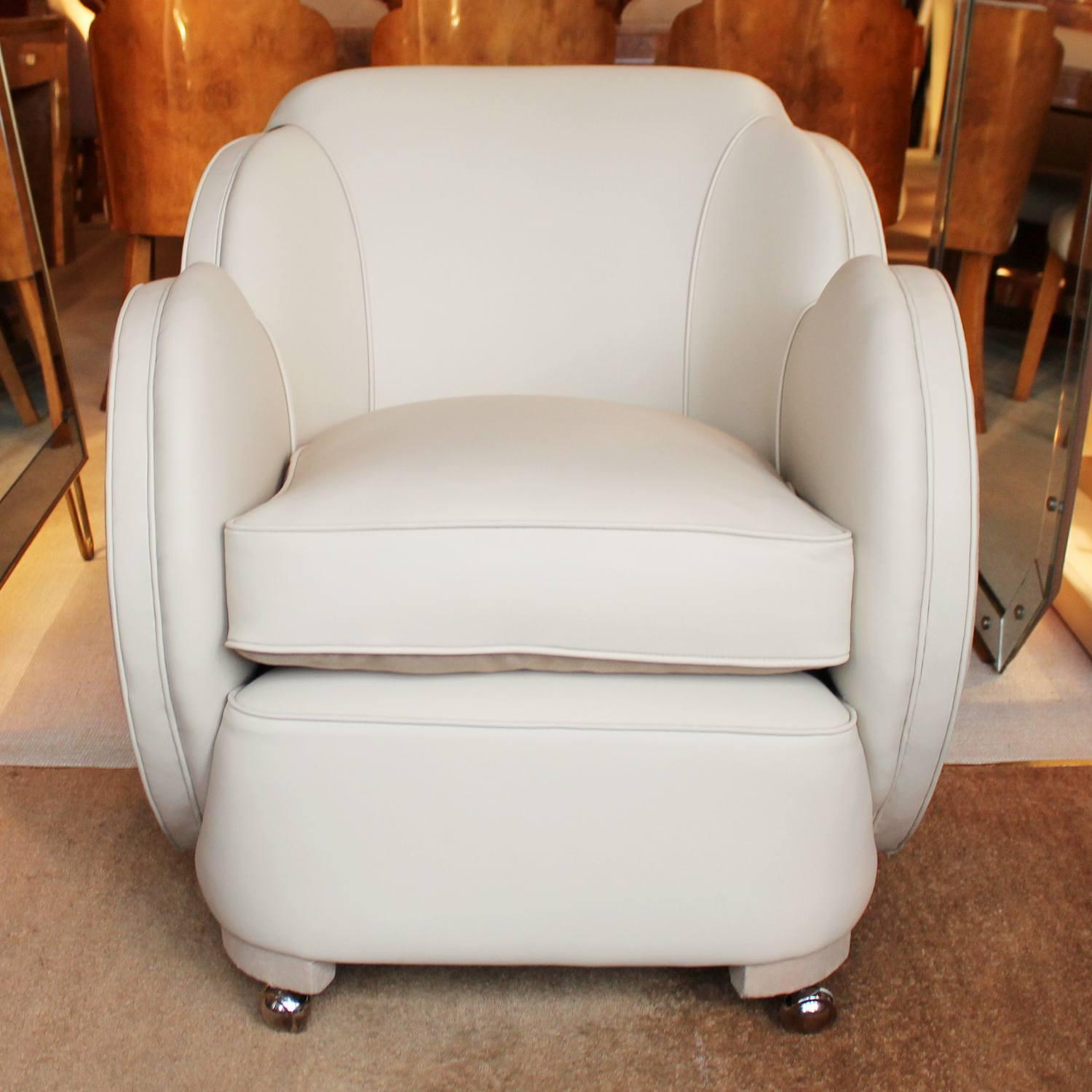 A pair of Art Deco, cloud back armchairs. Upholstered in cream leather and contrast Alcantara suede with later casters.



 