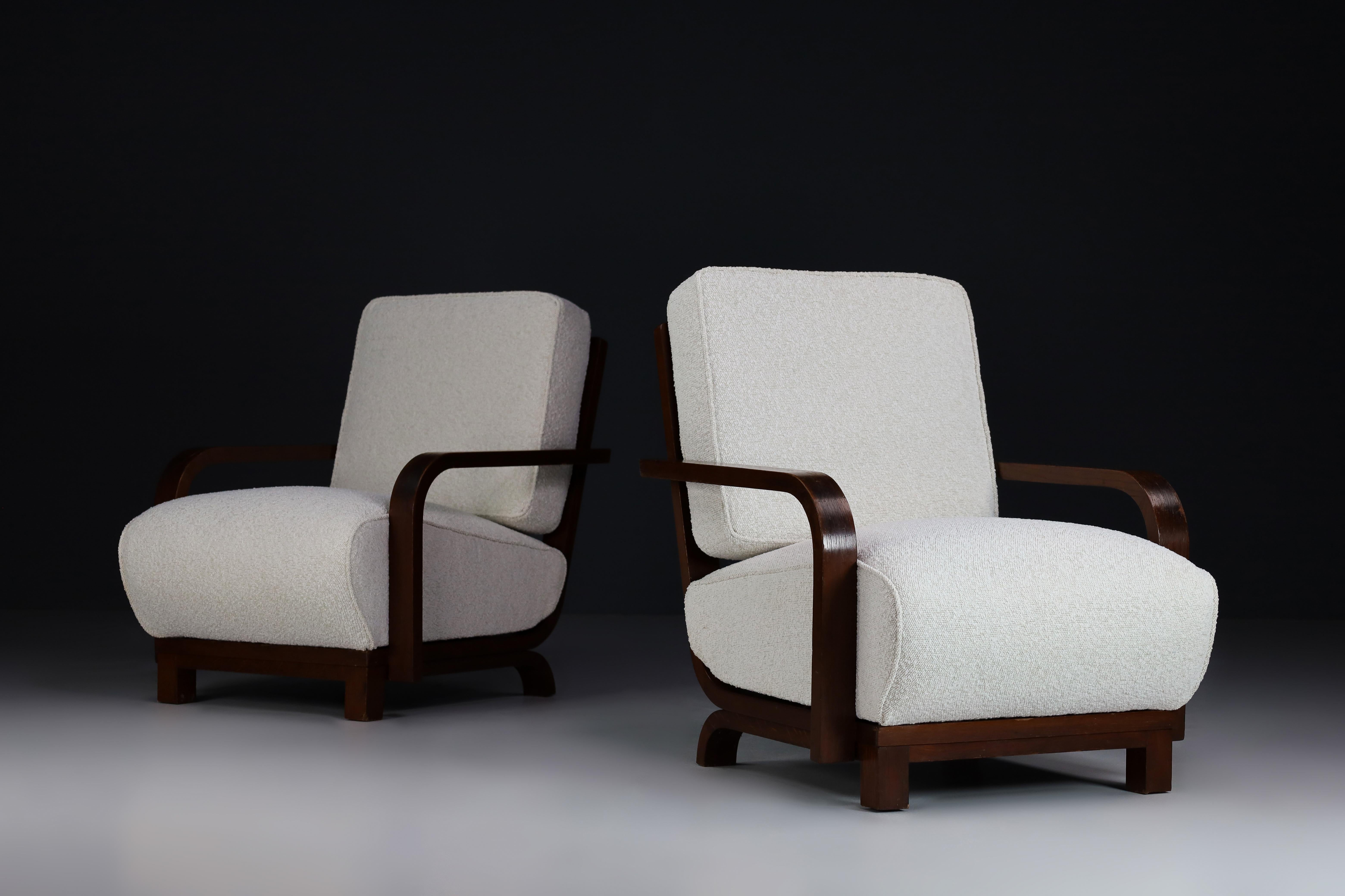 Art Deco armchairs in bentwood and bouclé upholstery, Prague, the 1930s.

Set of two Art Deco armchairs in bentwood and new bouclé upholstery, Czech Republic 1930s. These lounge chairs would make an eye-catching addition to any interior, such as a